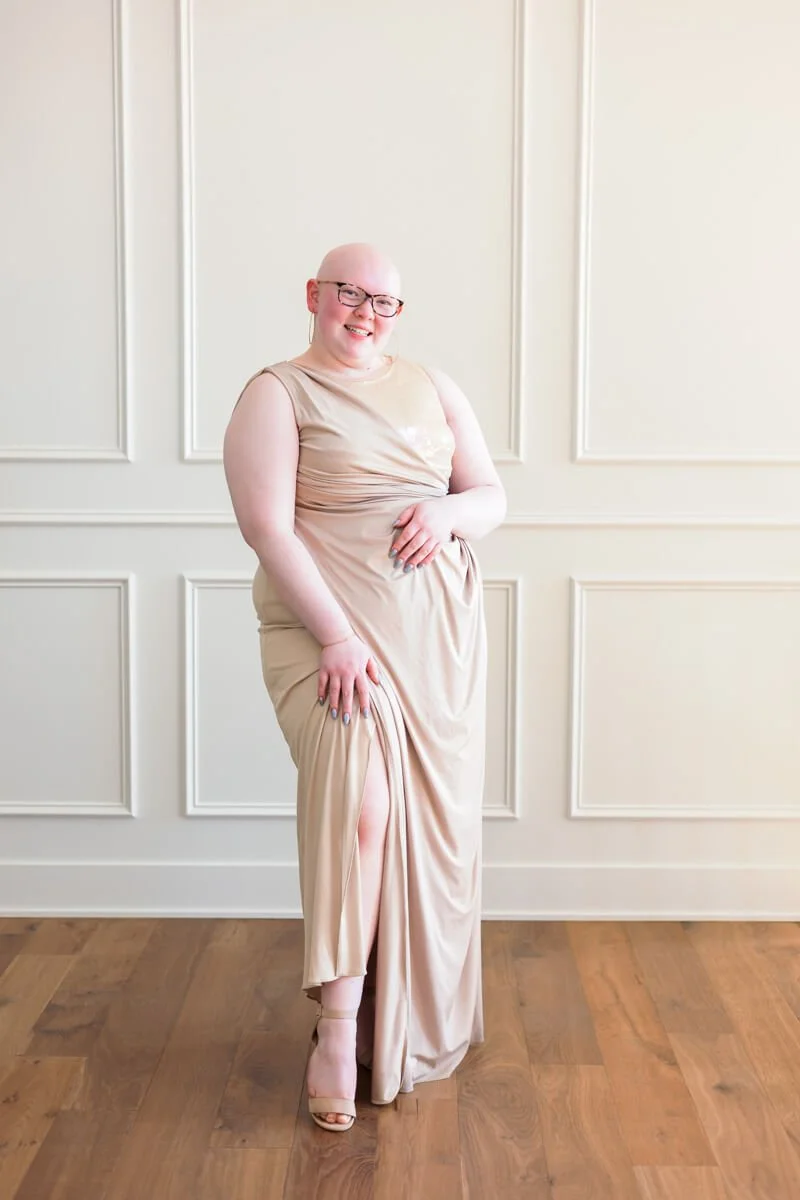 Senior girl modeling a champagne colored prom dress purchased from a Des Moines thrift store.