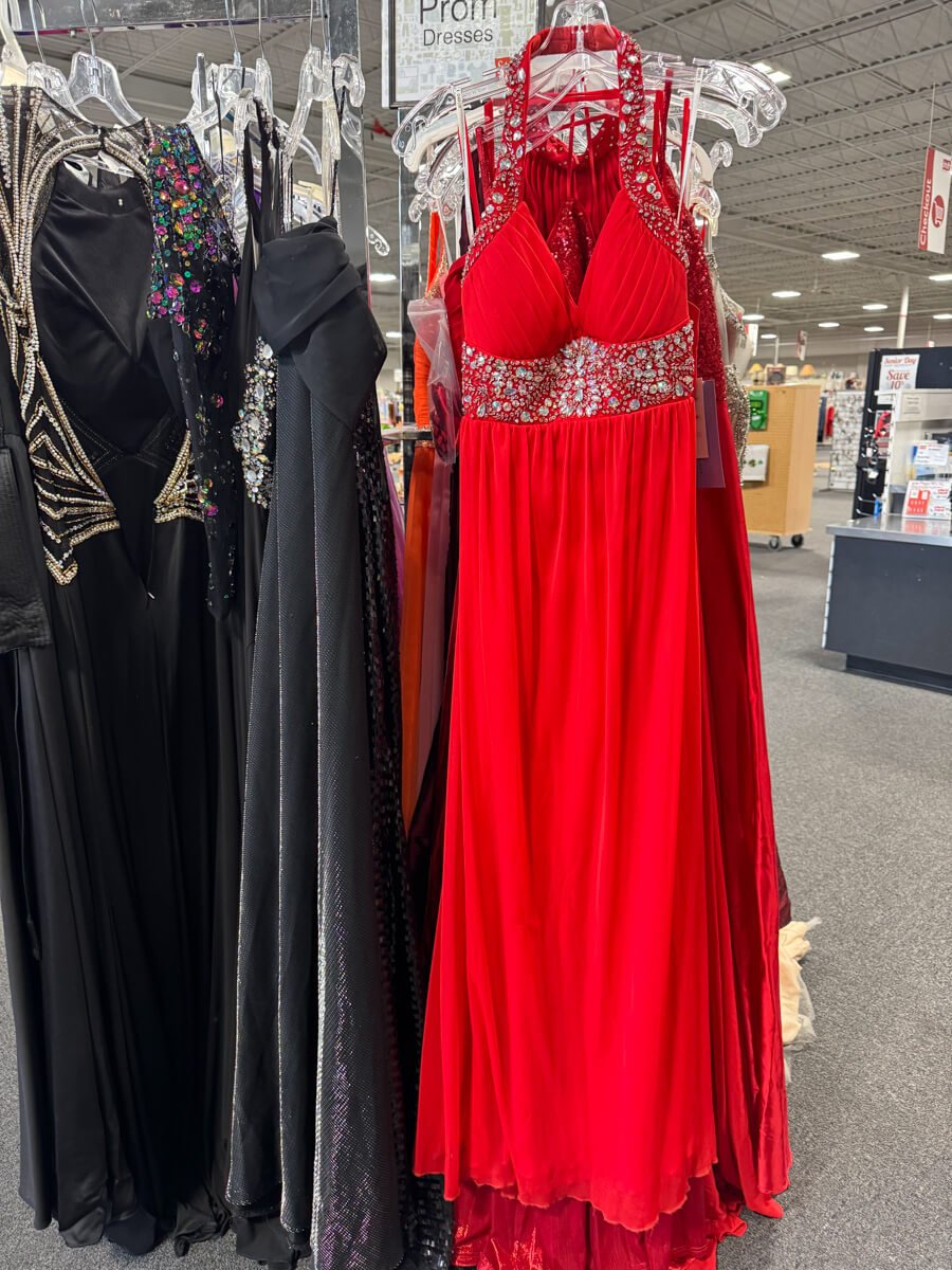 Rack of gently used red and black prom dresses at Stuff Etc in Clive, Iowa.