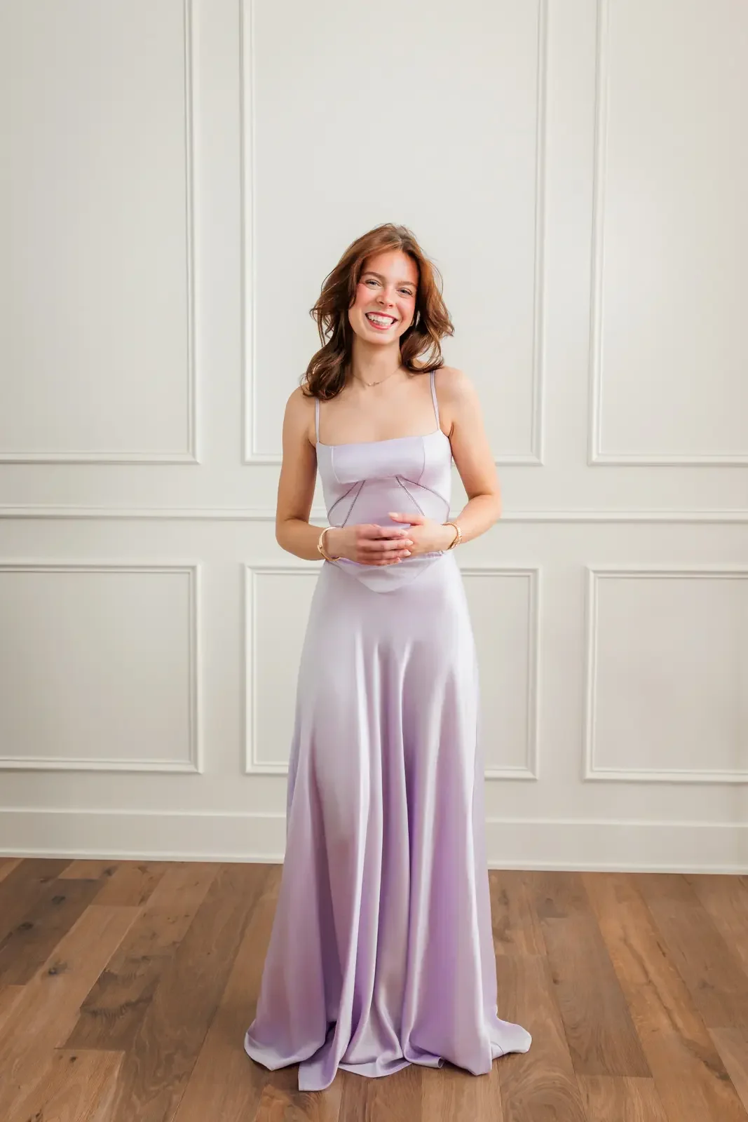 Senior girl wearing a lavendar floor length prom dress.