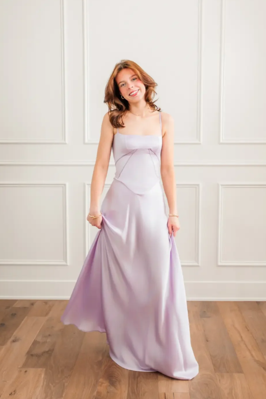 Senior girl wearing a lavendar floor length prom dress.