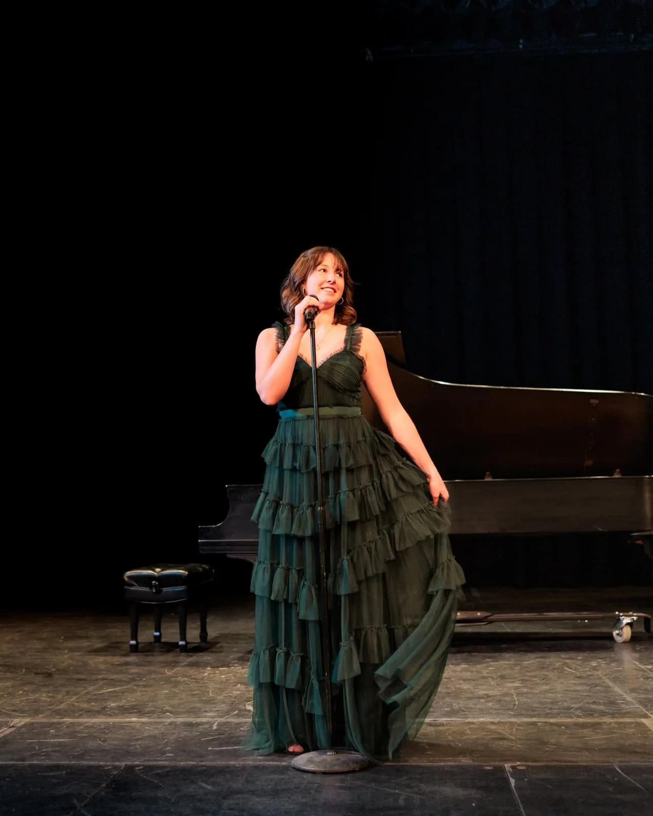 Teen girl singing on stage at Hoyt Sherman Place in Des Moines.