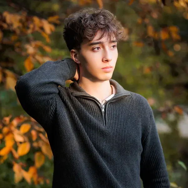 Senior boy wearing a dark gray quarter zip sweater.