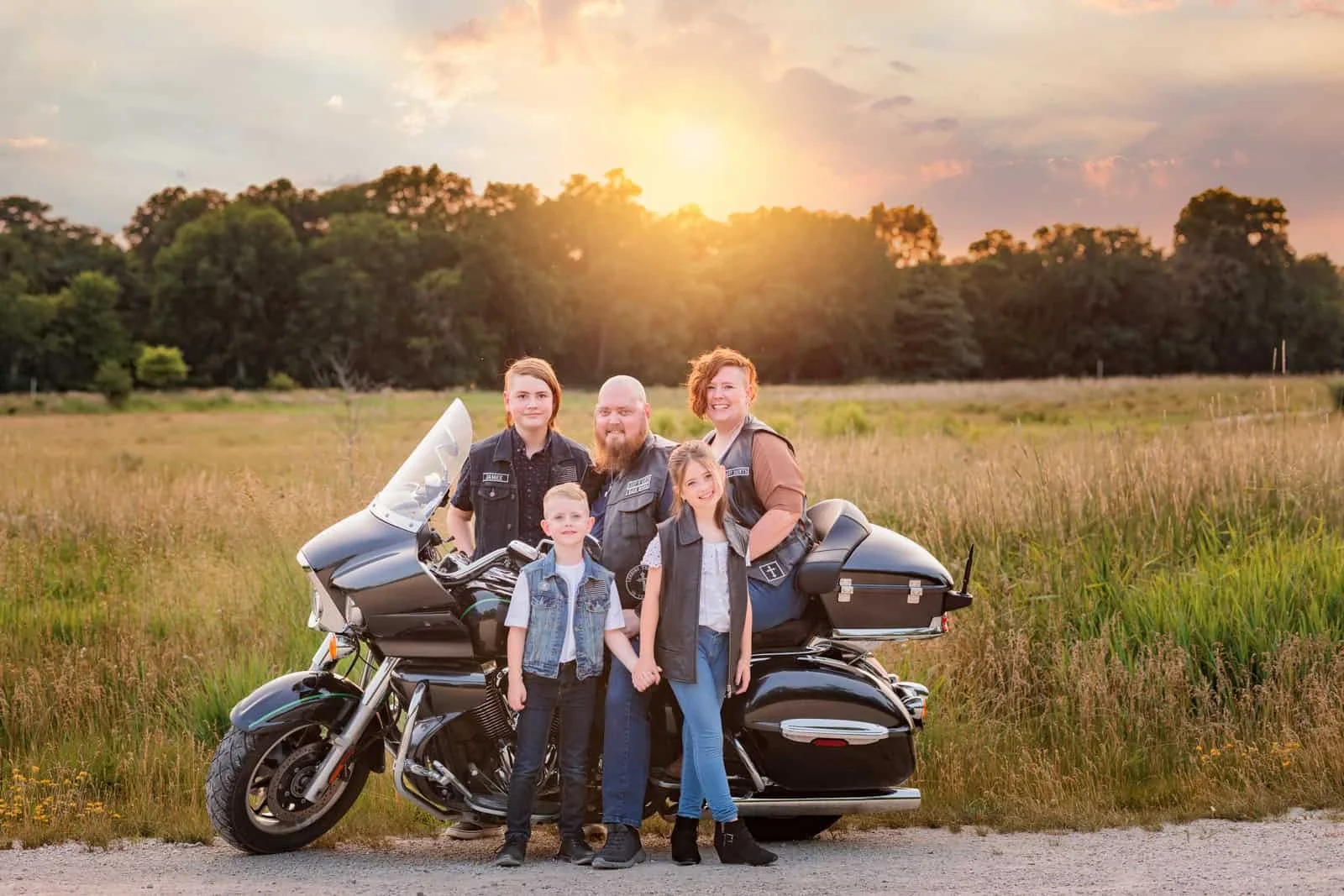 Family of 5 posing with their motorcycle at sunset in Des Moines.