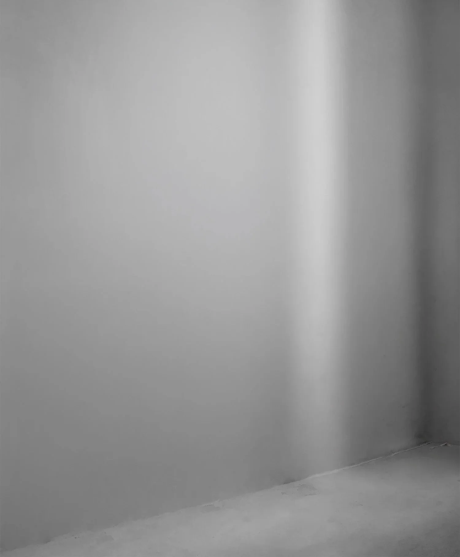 Empty room with gray walls and concrete floor.