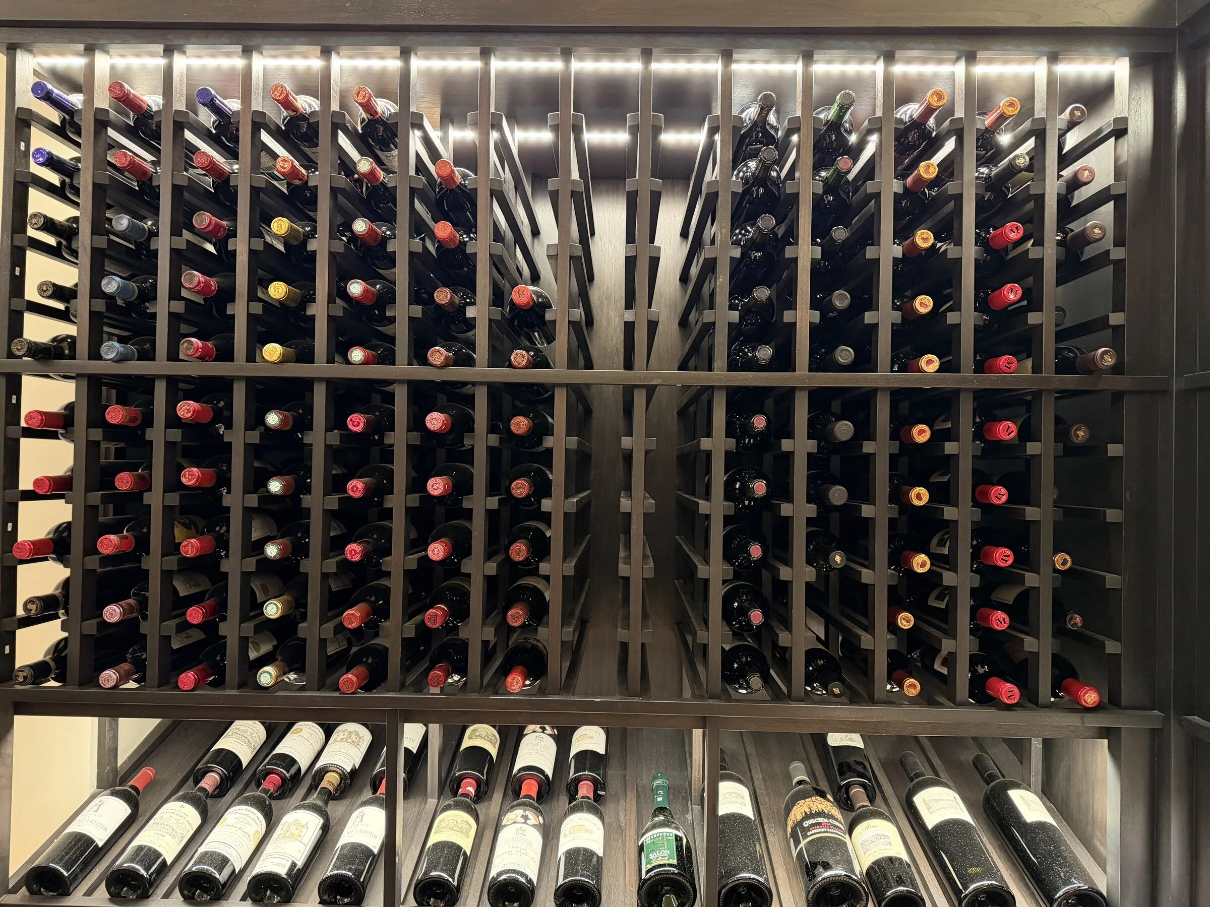 Private wine collection arranged bottle by bottle during professional cellar work