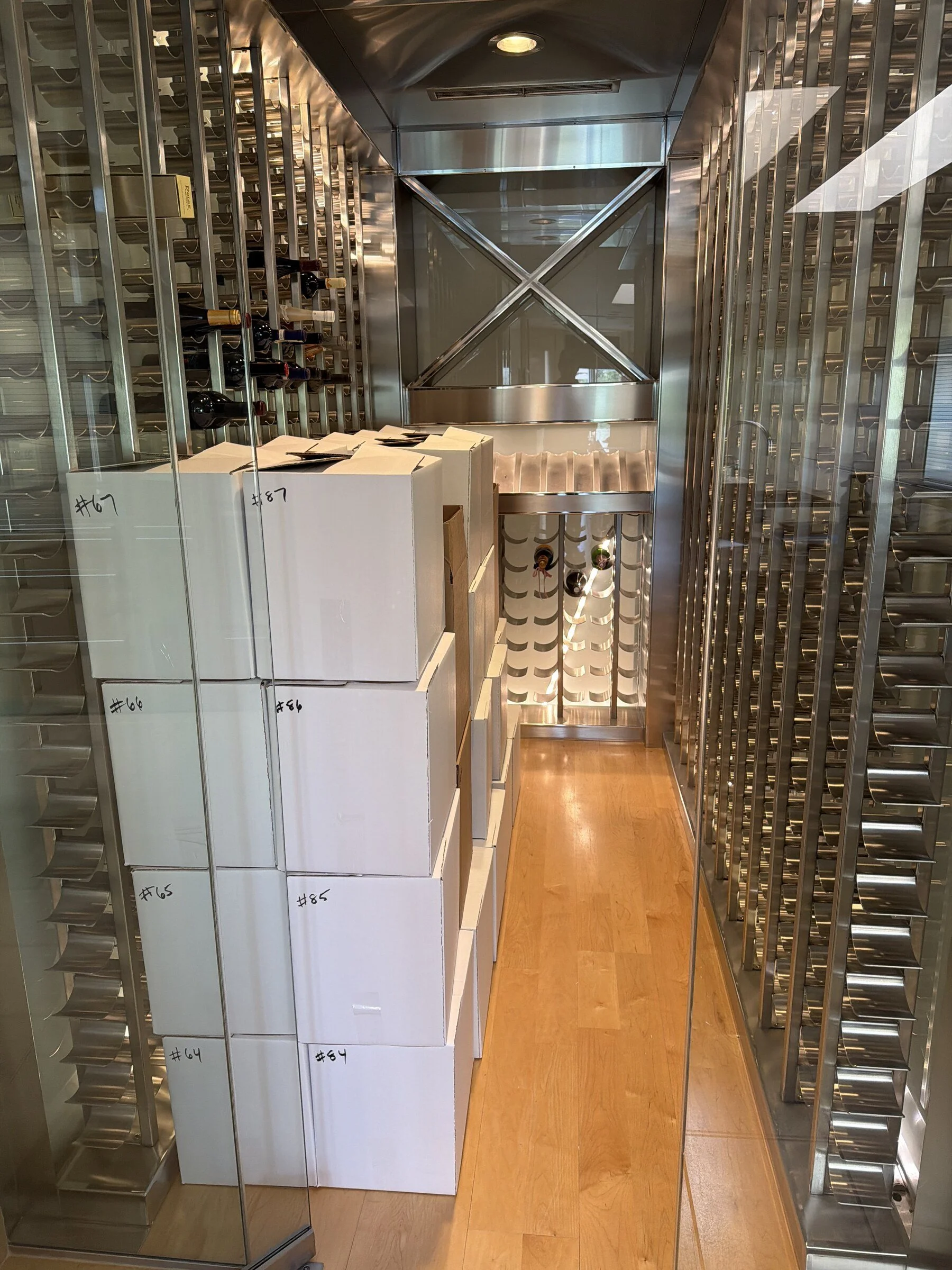 Wine collection boxed and organized for valuation and potential sale