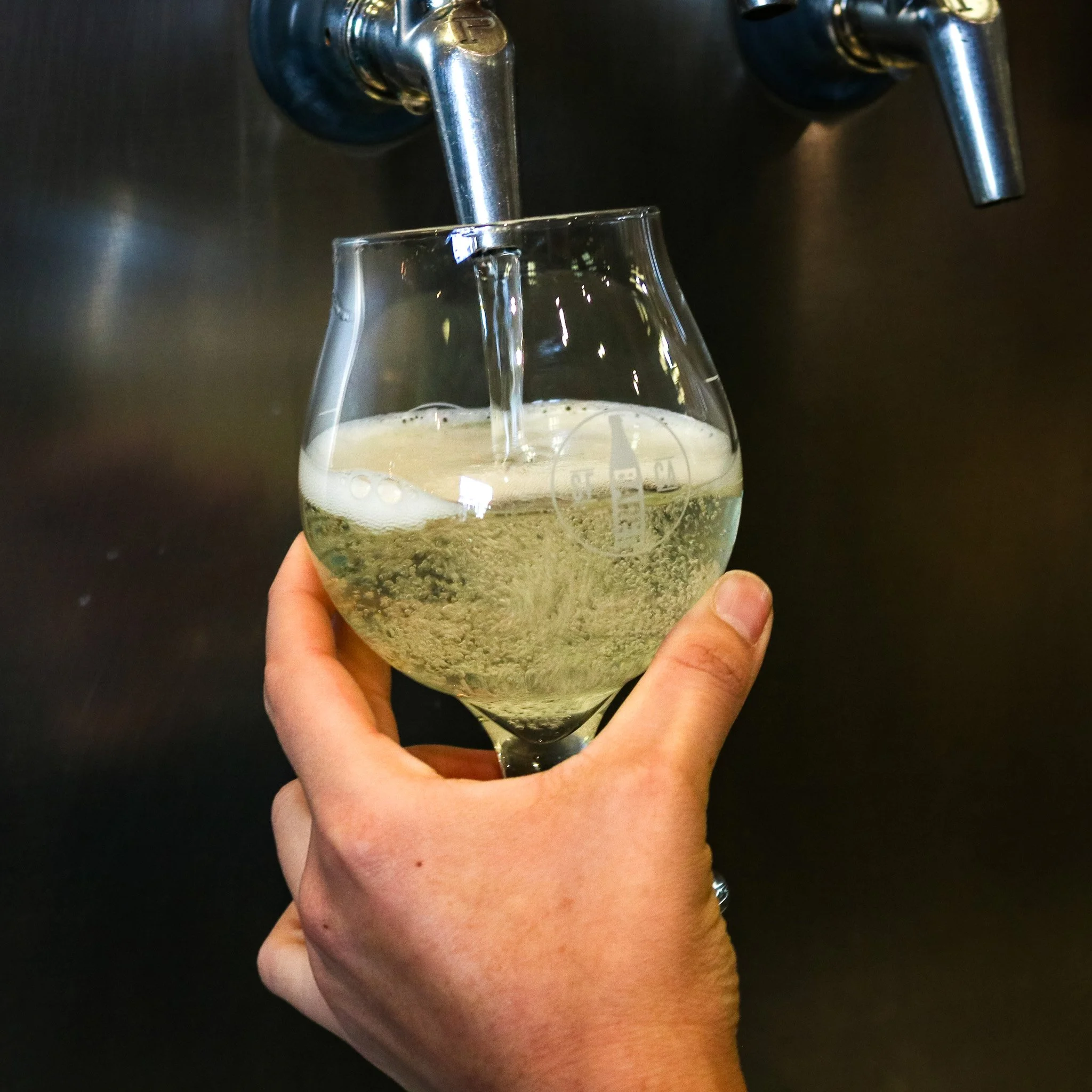 Hop water being poured from tap.
