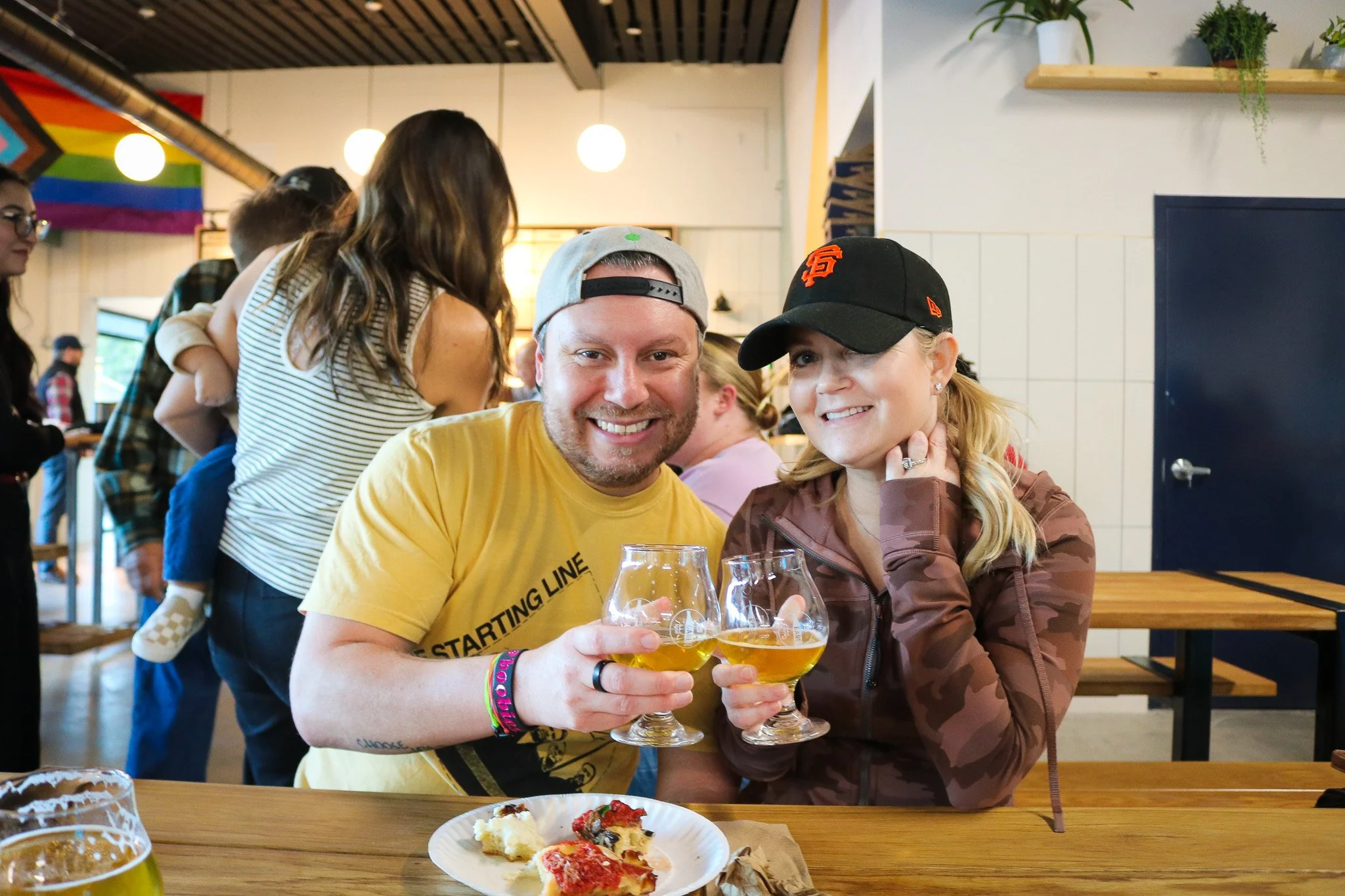 Image of couple at Walnut Creek taproom smiling and drinking beer