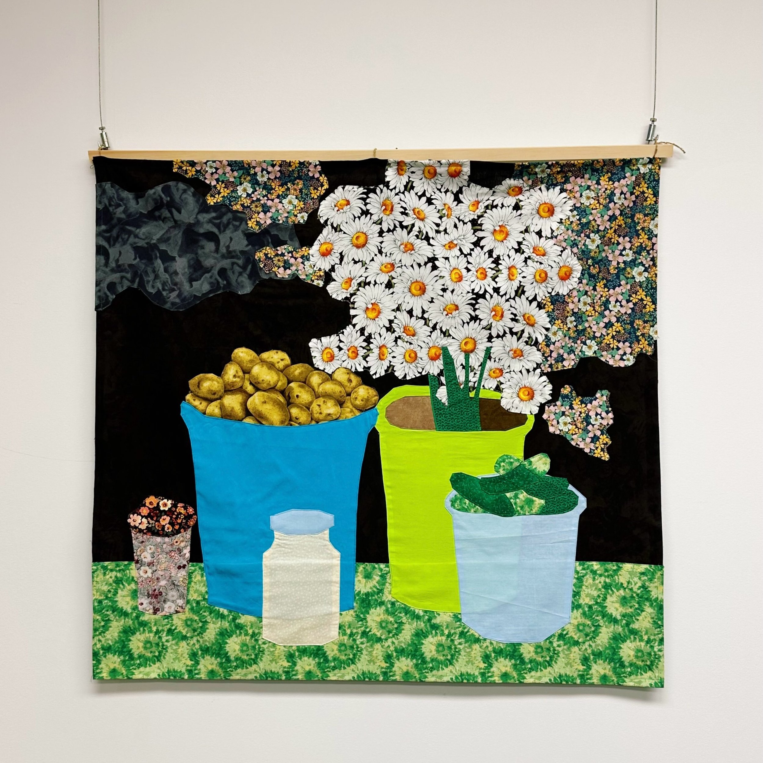 By the Roadside by @oksana_briukhovetska 
Textile collage, 2025.

In Ukrainian villages and in small markets in cities and towns, people sell vegetables, flowers, and other goods from their gardens. These fruits of their labour and harvest are symbol