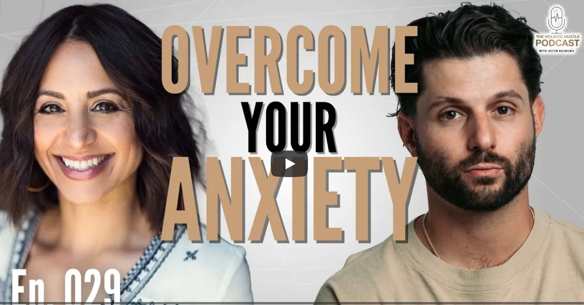 A woman with shoulder-length dark brown hair smiling and a serious man with dark hair and beard, with text overlay saying "Overcome Your Anxiety" and a logo in the top right corner for The Holistic Hustle Podcast.