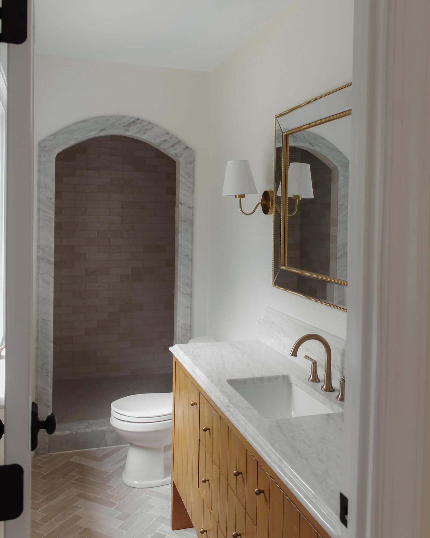 Narrow walls are a tough design obstacle when it comes to bathroom renovations. The hand selected finishes + hardware, detailed scalloped edges, cave shower, variation of shapes + patterns, functionality, and transition points make this space feel a 