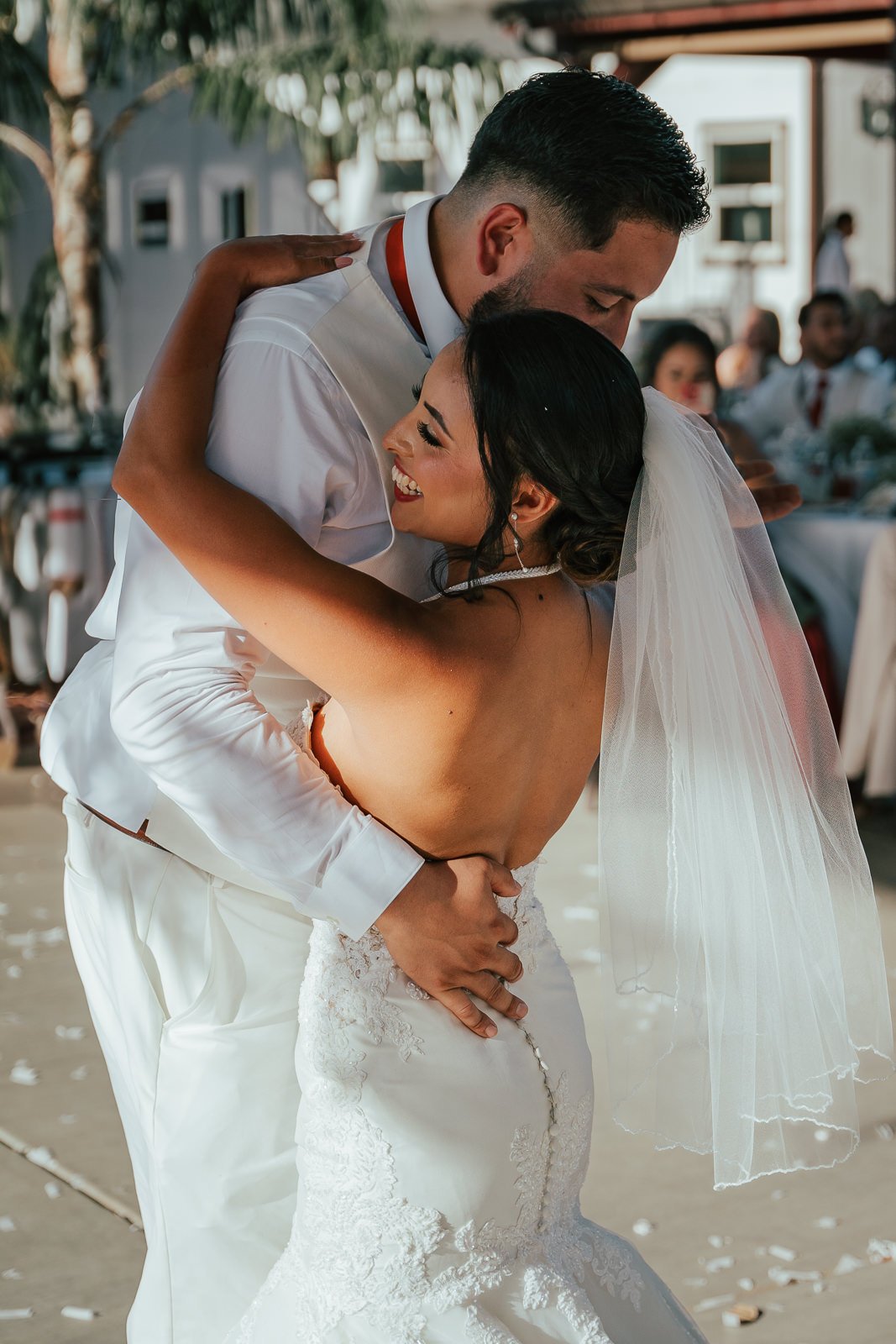 Bride and groom embracing during first dance at wedding.