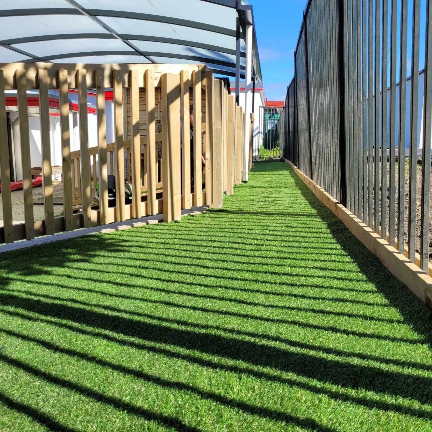 Green artificial lawn neatly installed