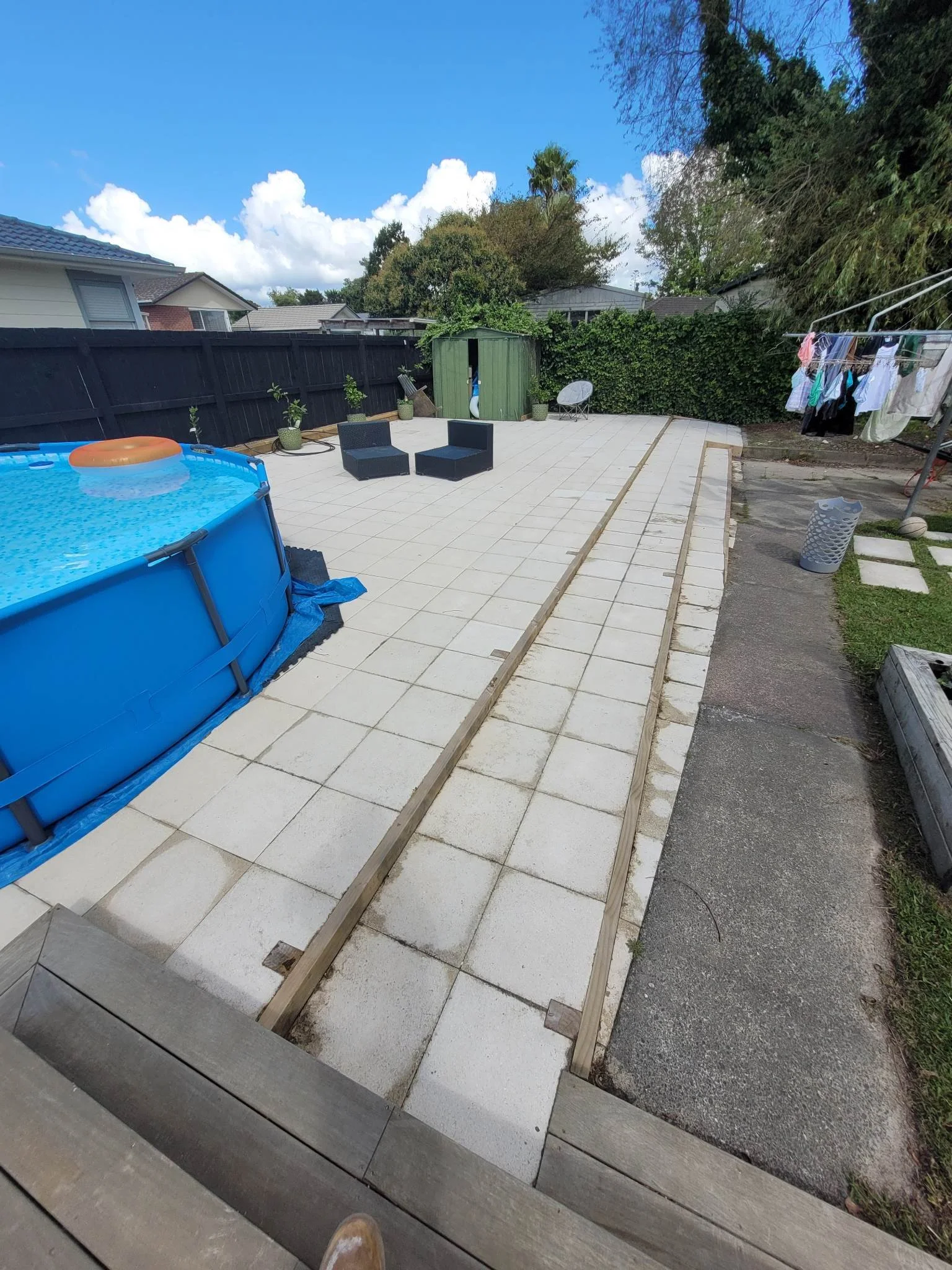 paved patio for above ground pool and furniture