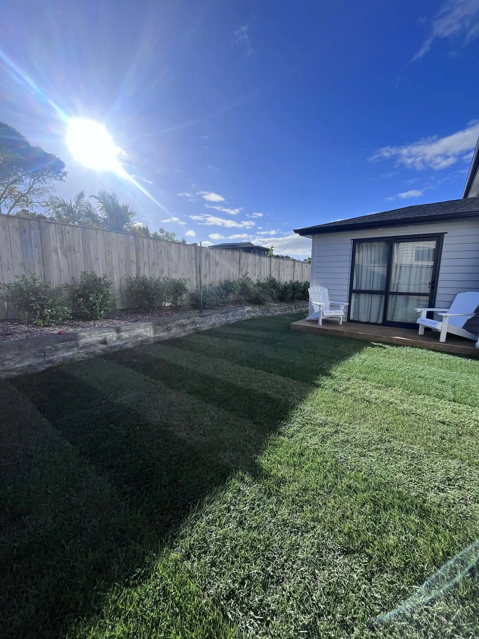 lush new ready lawn with new hedging on retaining wall