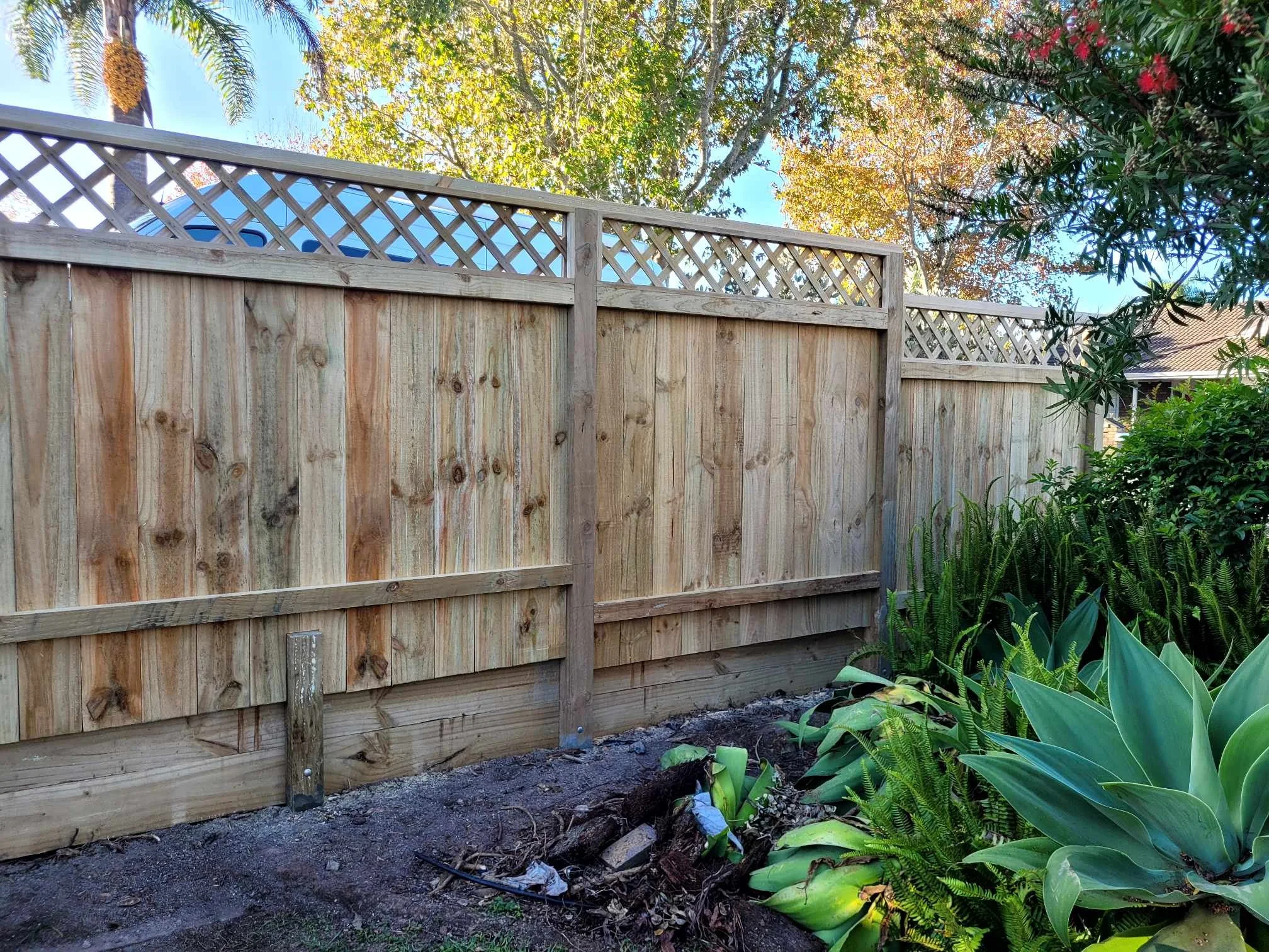 fence on retaining wall with trellis