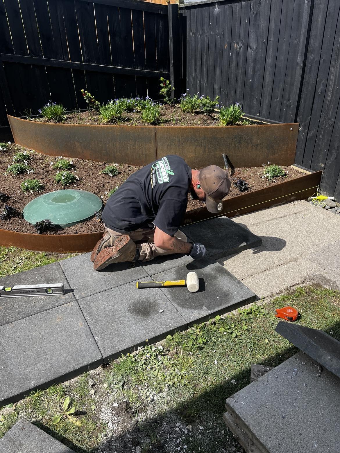 Installing pavers next to the Corten edging garden beds 