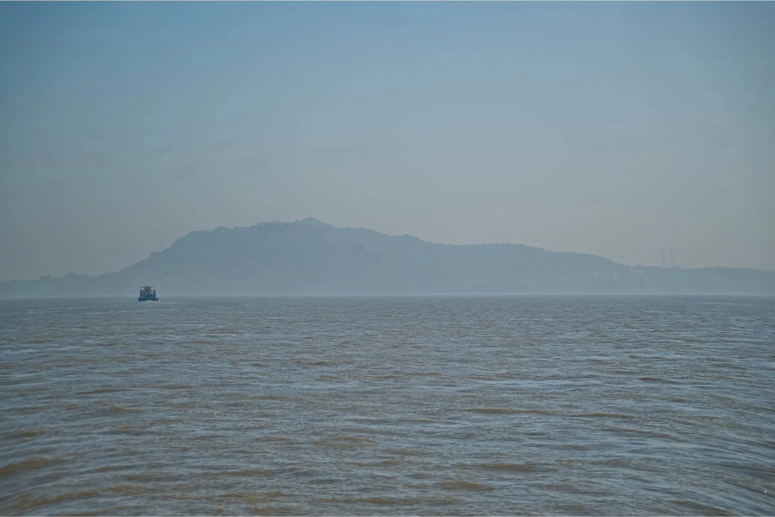 Elephanta Island rises from the mist and smog