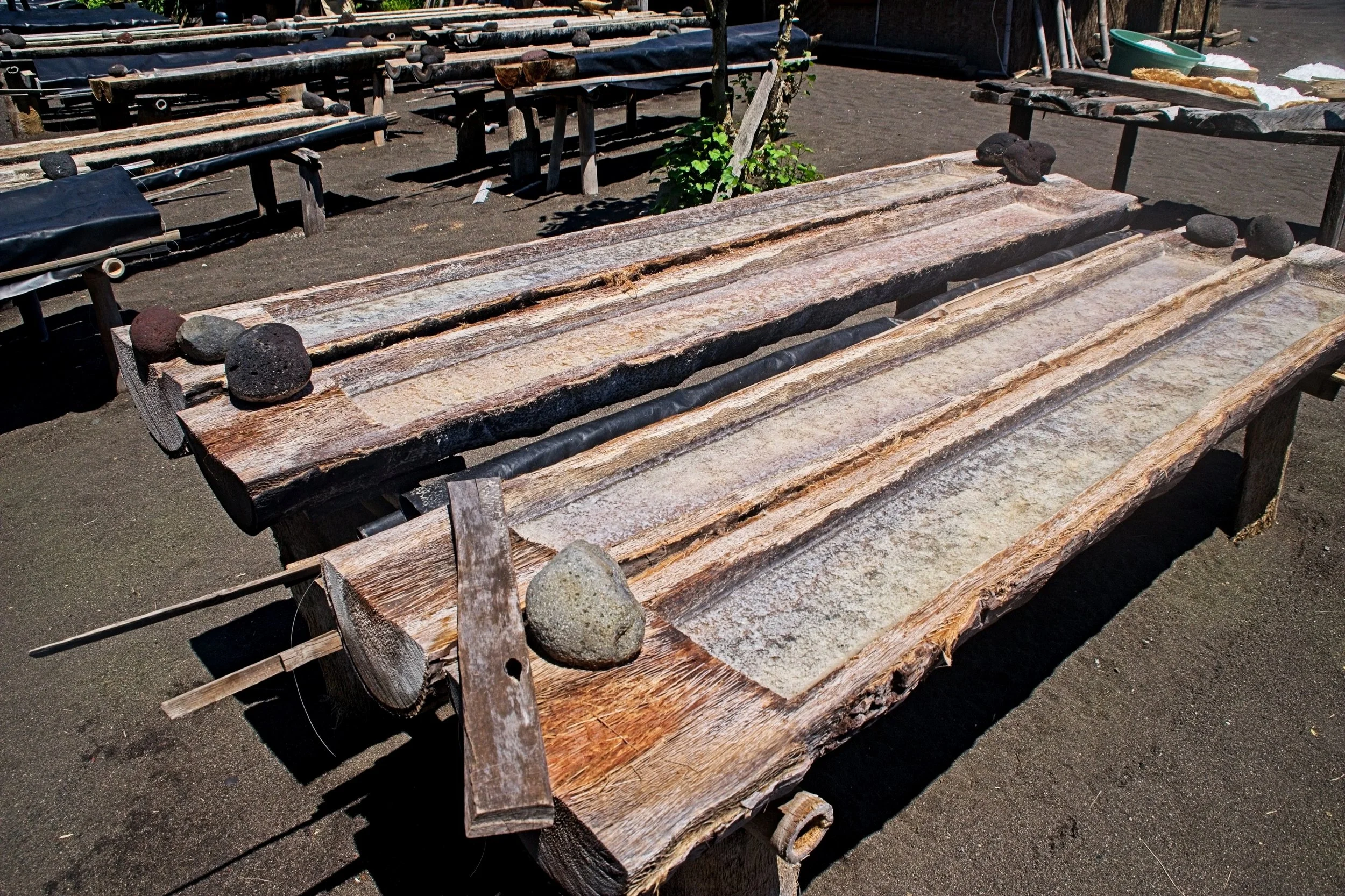 The drying troughs out in the sun. Evaporation leaves pure salt crystals.