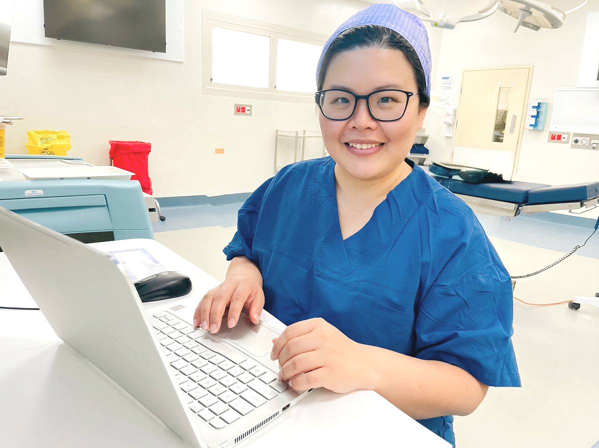 Dr Suat Chin Ng, colorectal surgeon, working in the operating theatre