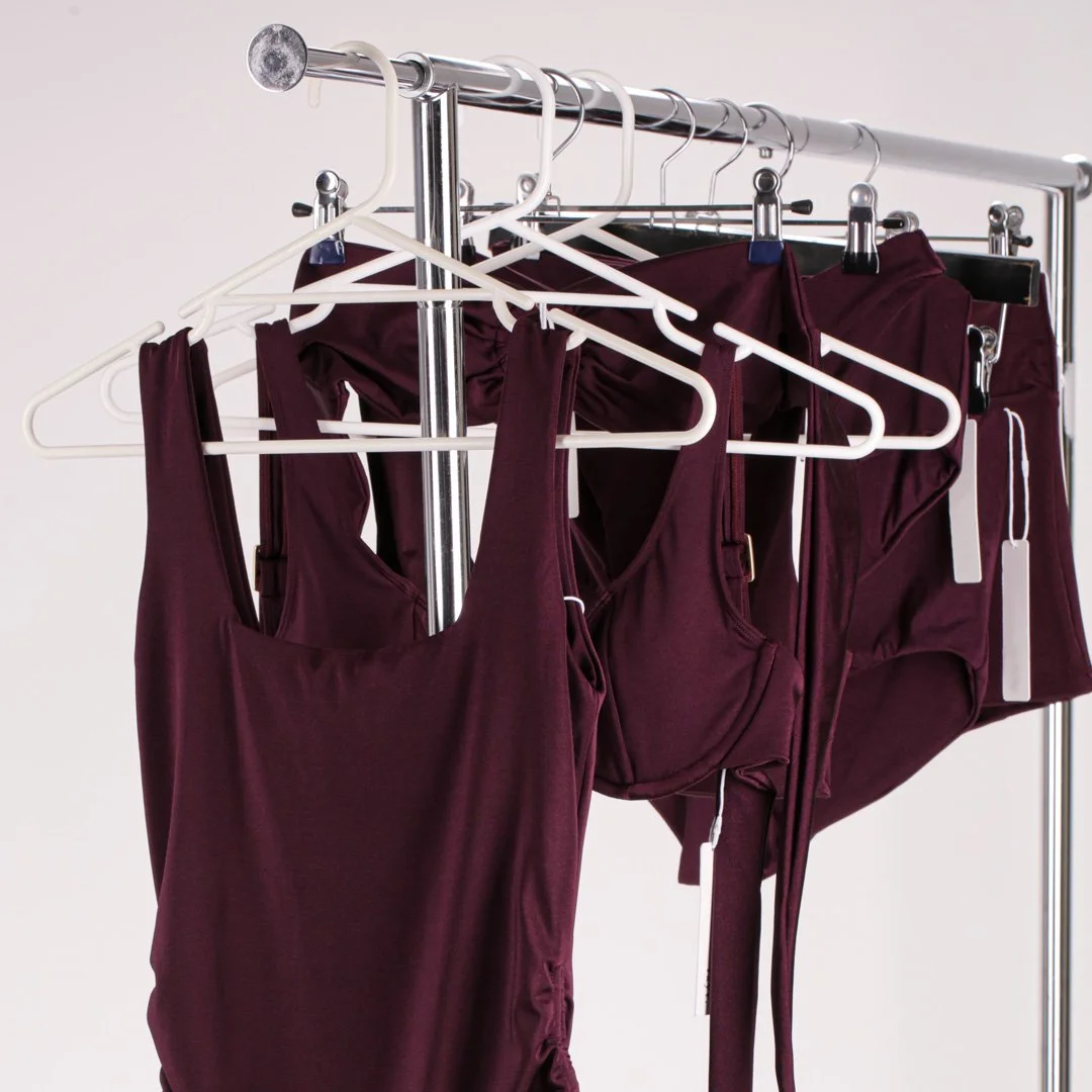 Swimwear collection hanging on the studio rack