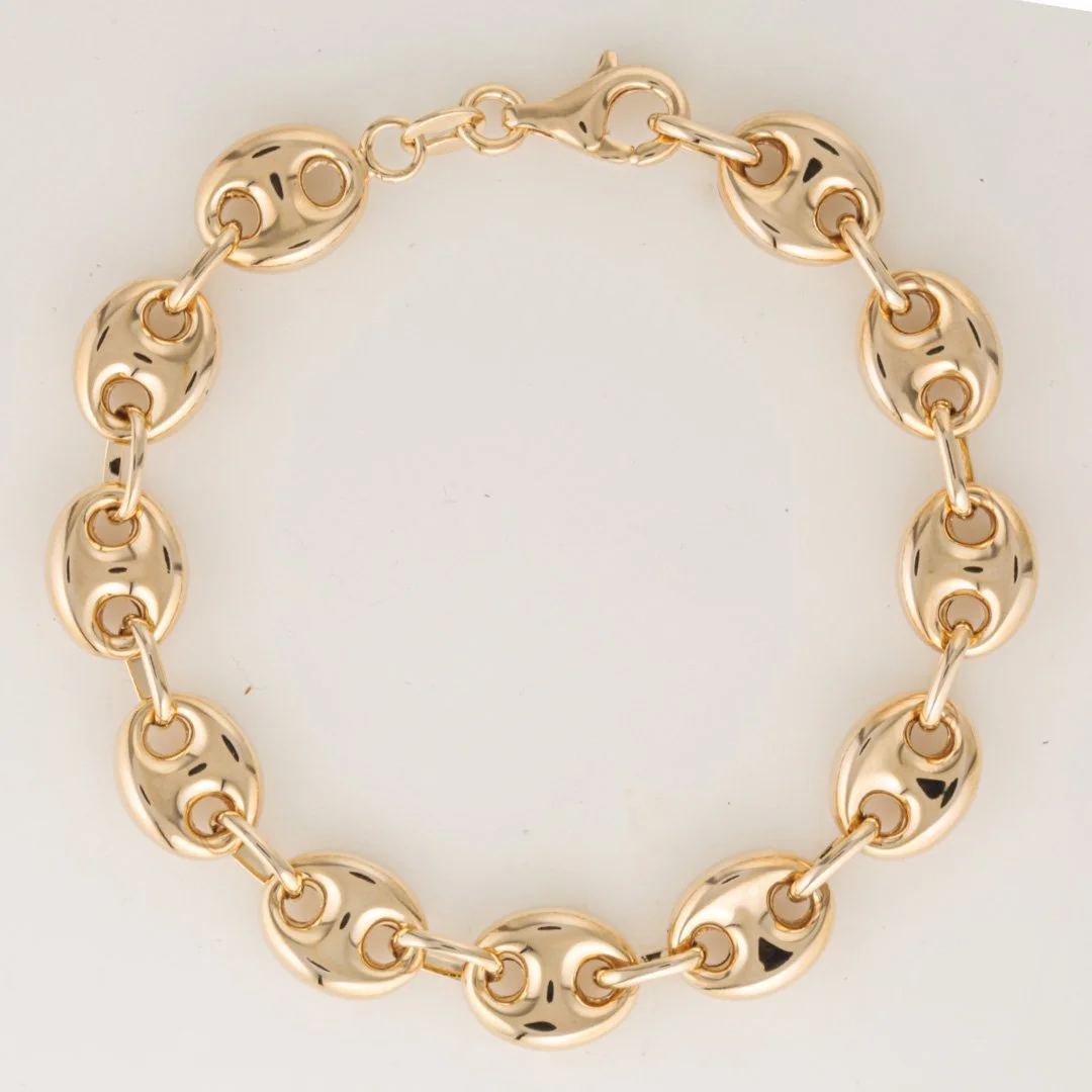 Original studio photograph showing the gold bracelet arranged in a circular shape