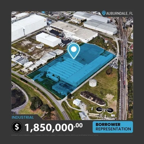 Aerial view of an industrial property in Auburndale, Florida, highlighted in blue, with a price of $1,850,000. The property is surrounded by roads and railroad tracks, and other industrial buildings can be seen nearby. A icon pinpoints the location on the property.