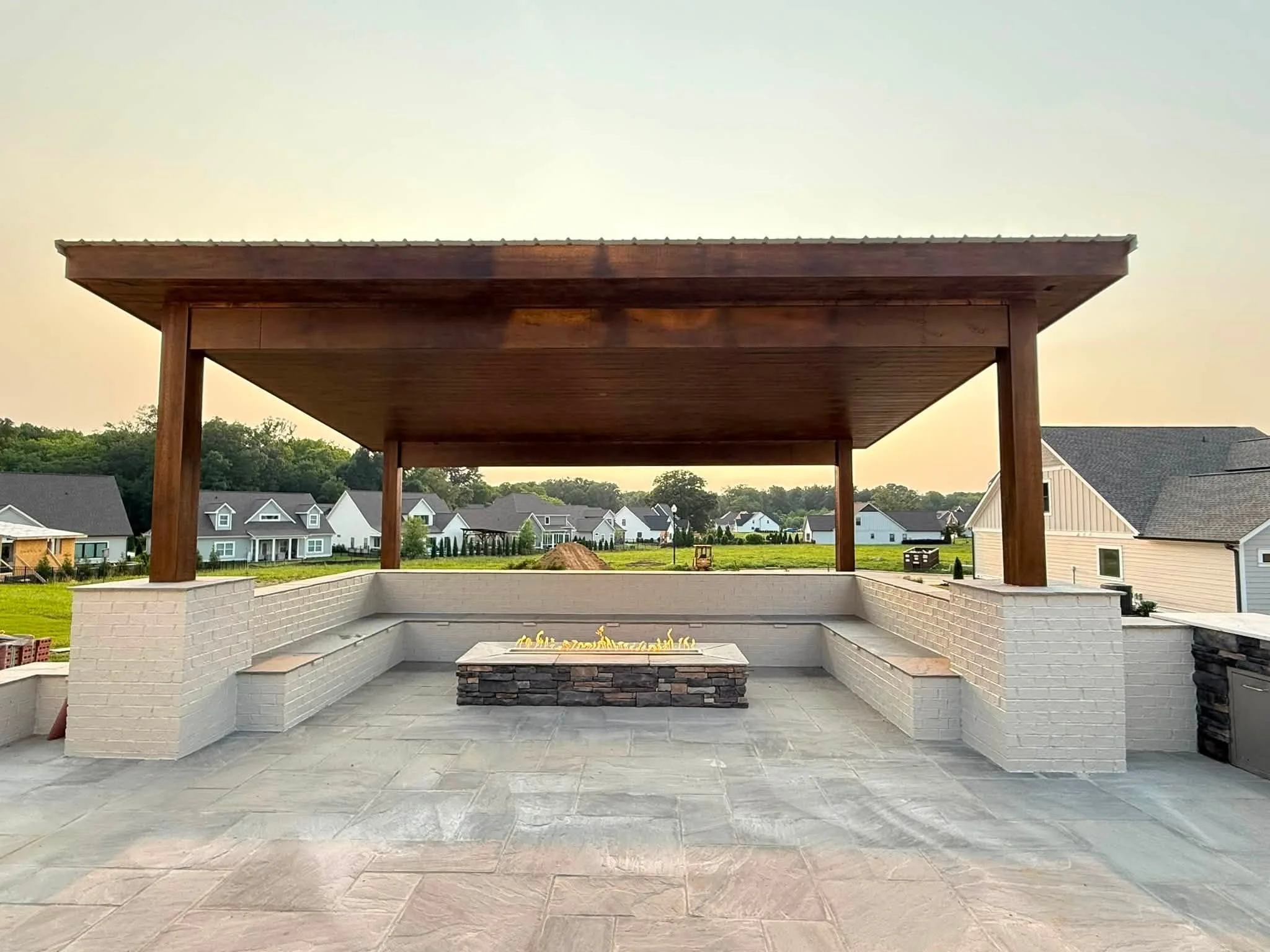 Flagstone patio with custom stair treads, planters, and a statue installed for Ooltewah, TN homeowner