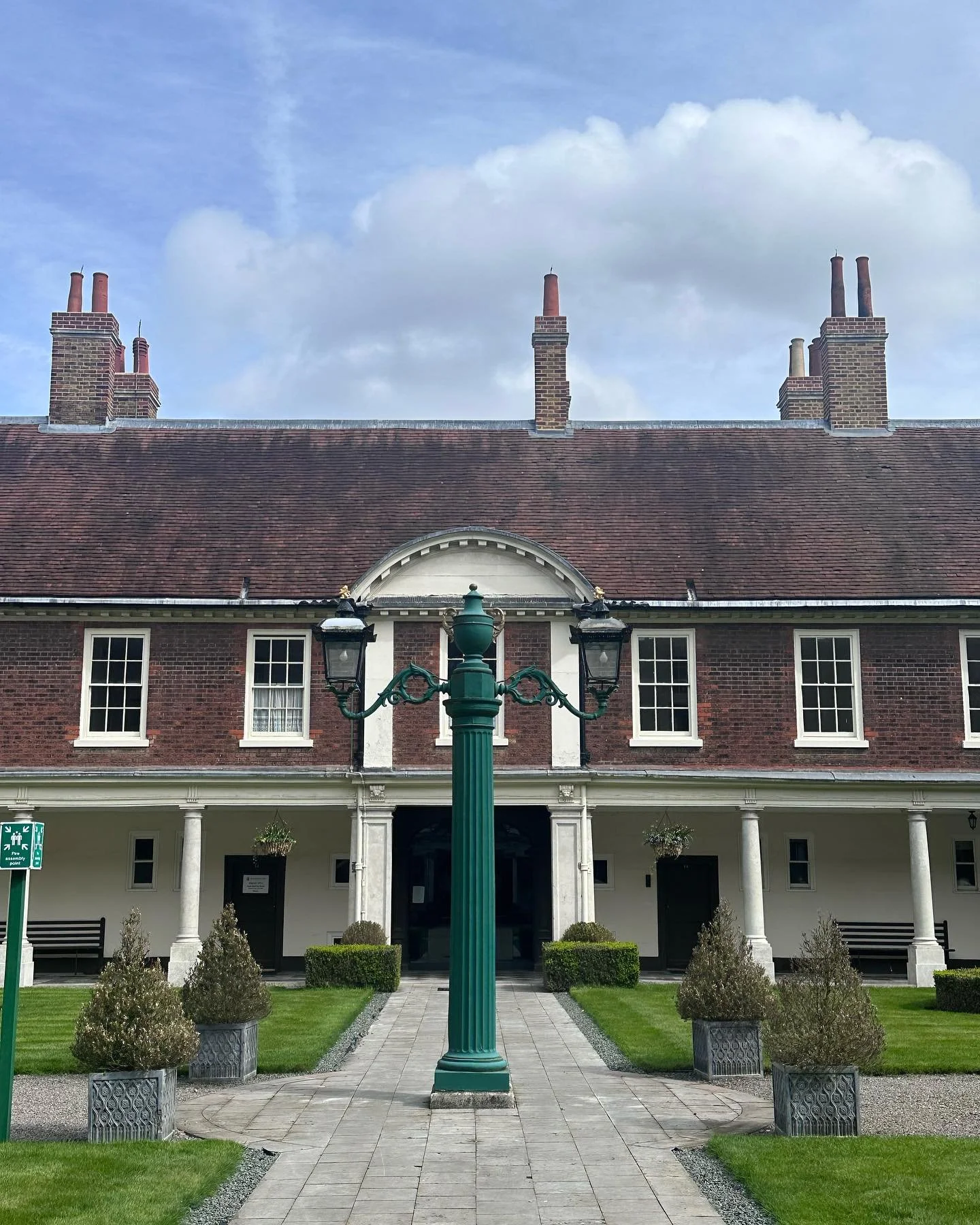 aCourtyard and grounds of a historic brick building