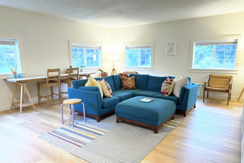 Colorful living room with a blue sectional at Longboard Cottage, a surfer's cottage in Seaside Oregon