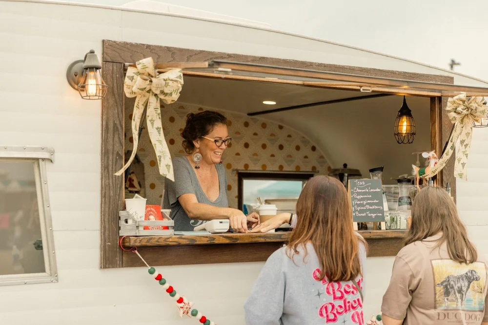 A vintage trailer shop dressed in holiday bows
