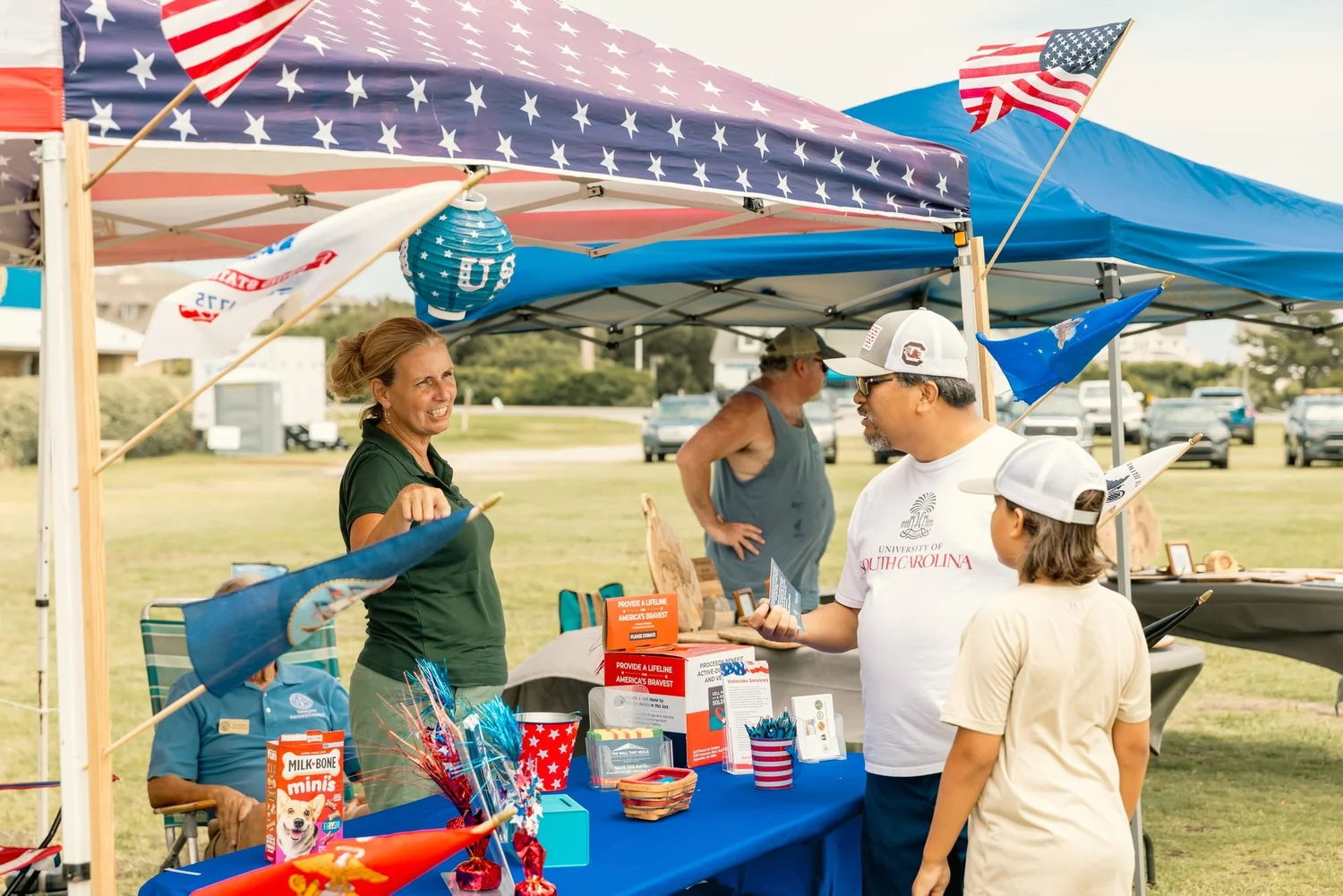 Shoppers at a star-spangled vendor booth