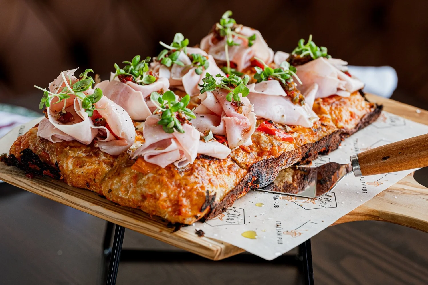 Roman-style pizza served on a board at Ella’s Italian Pub