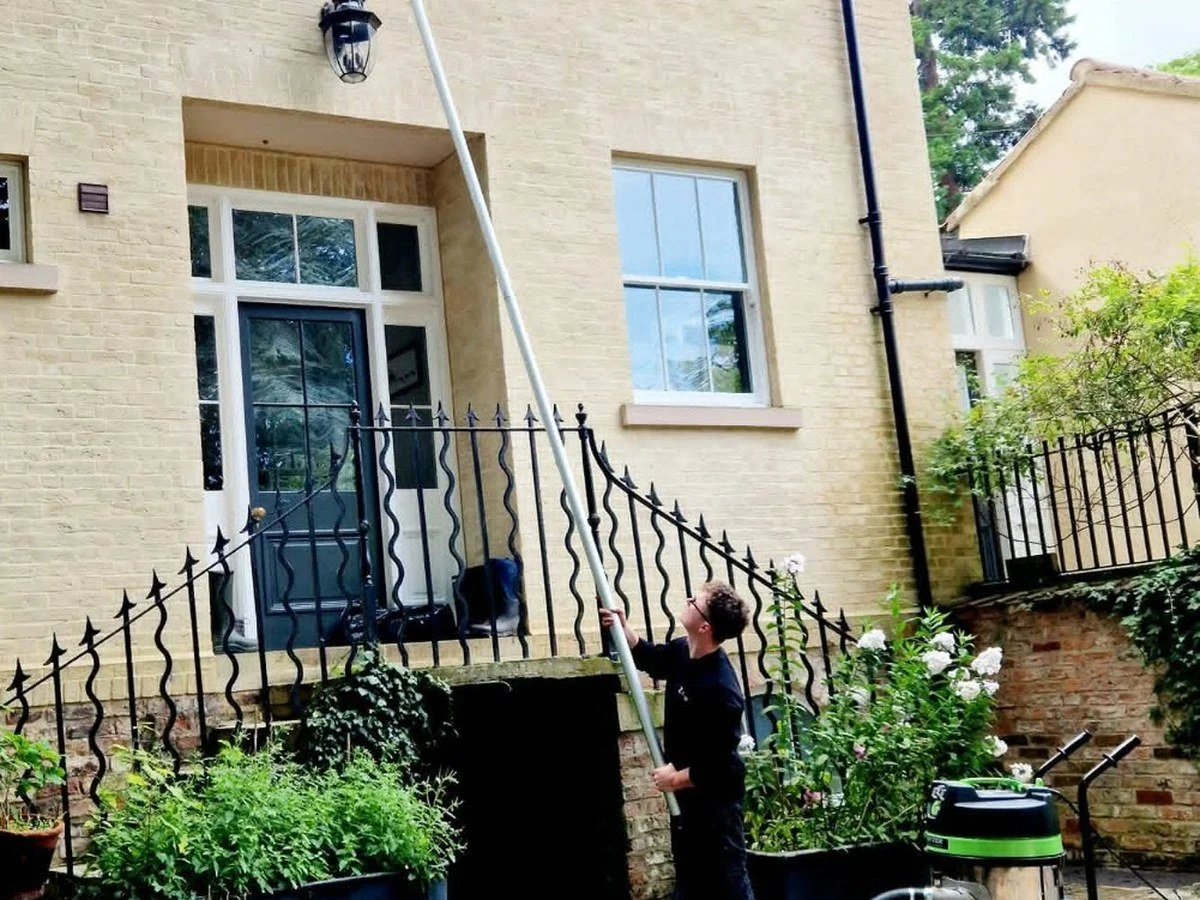 Industrial gutter-vacuum equipment clearing debris safely from guttering