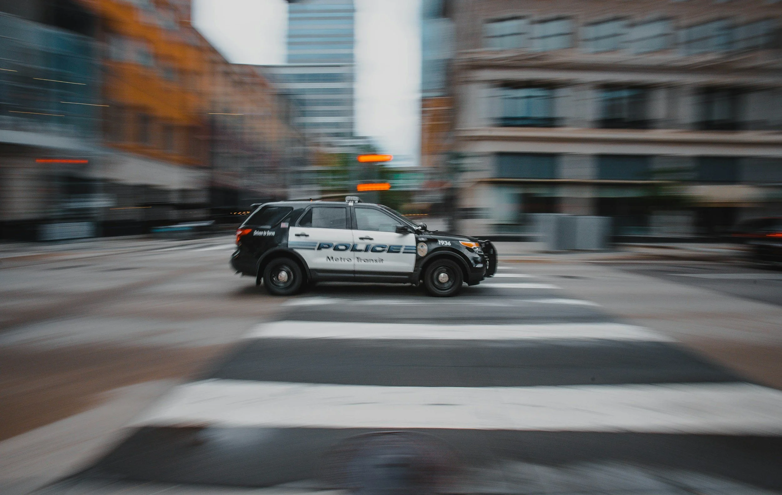 Police car racing through city streets