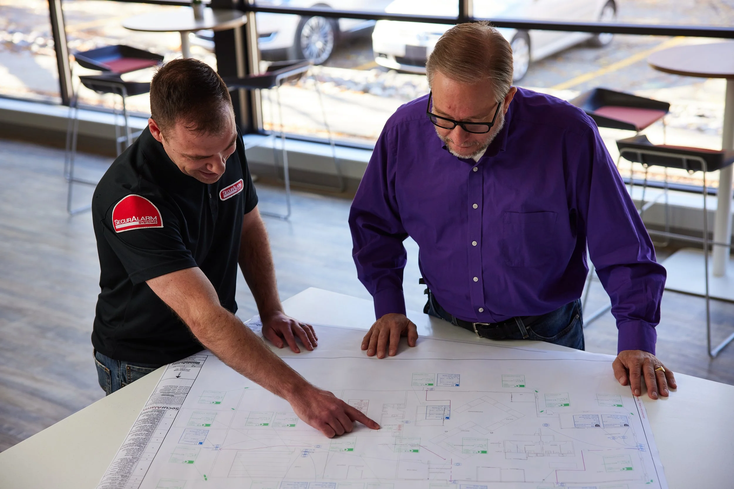 The SecurAlarm Team reviewing blueprints