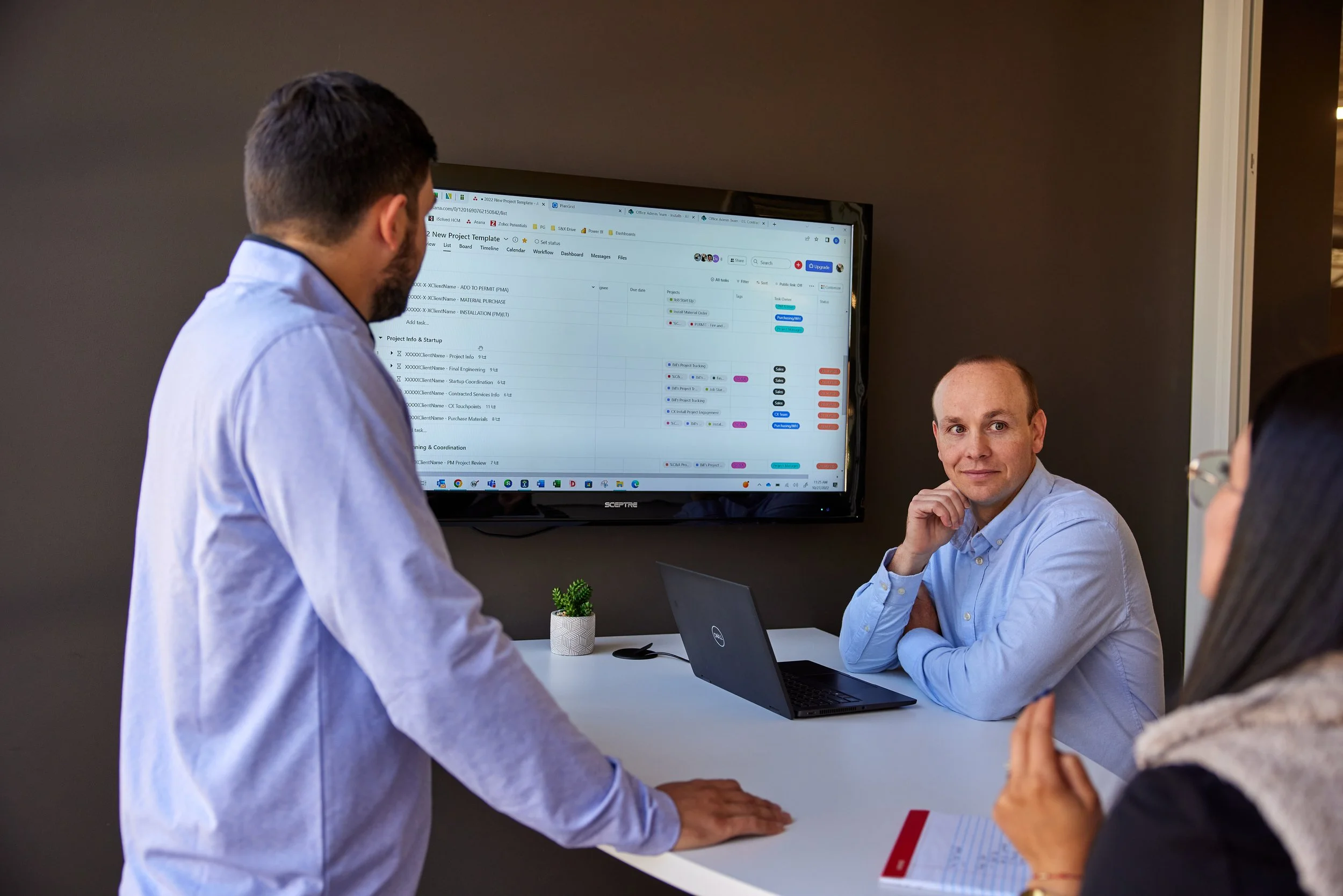 Accountants reviewing data on a monitor in conference room