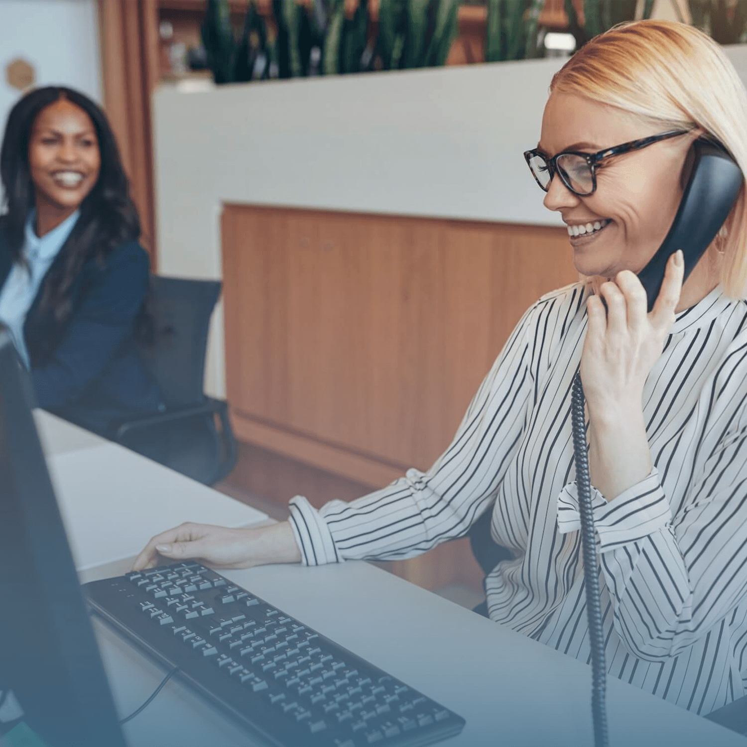 Bank employee answers phone at her desk.