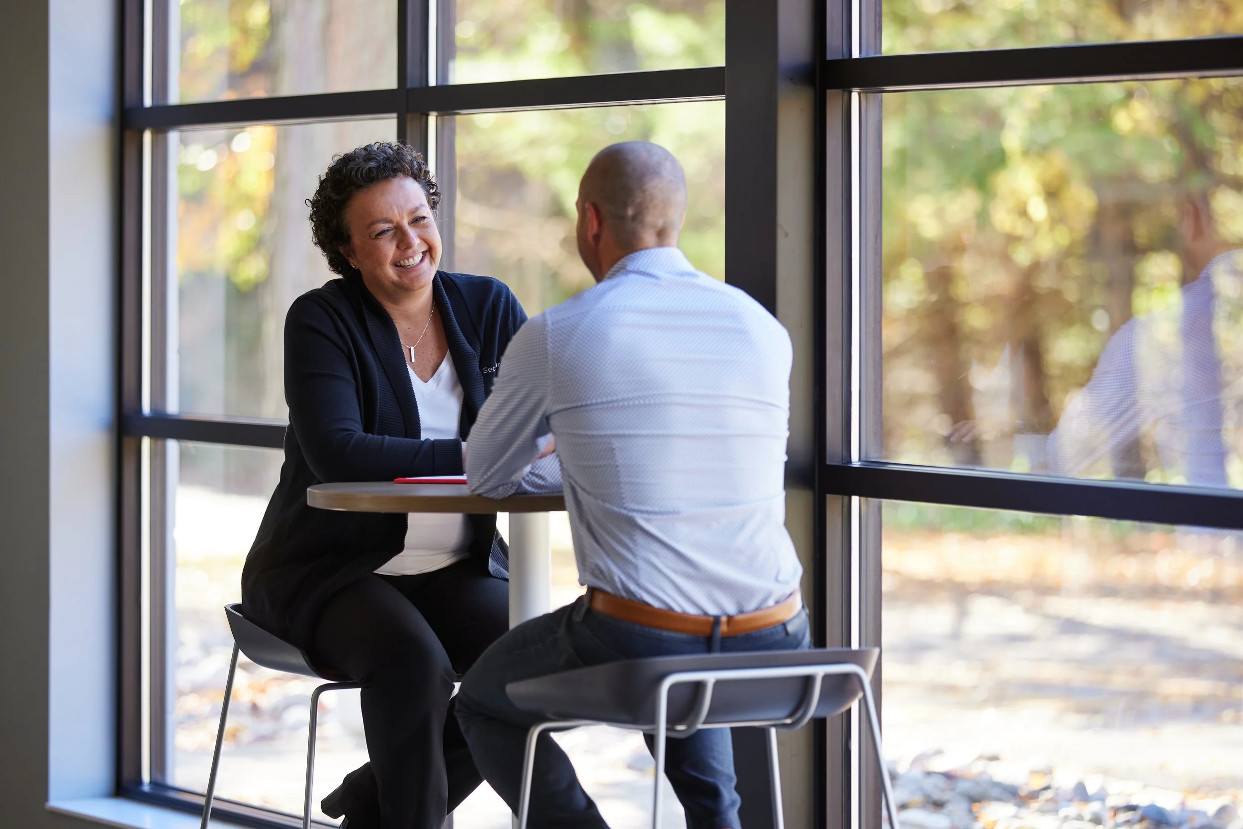 SecurAlarm team members having relaxed conversation in the office