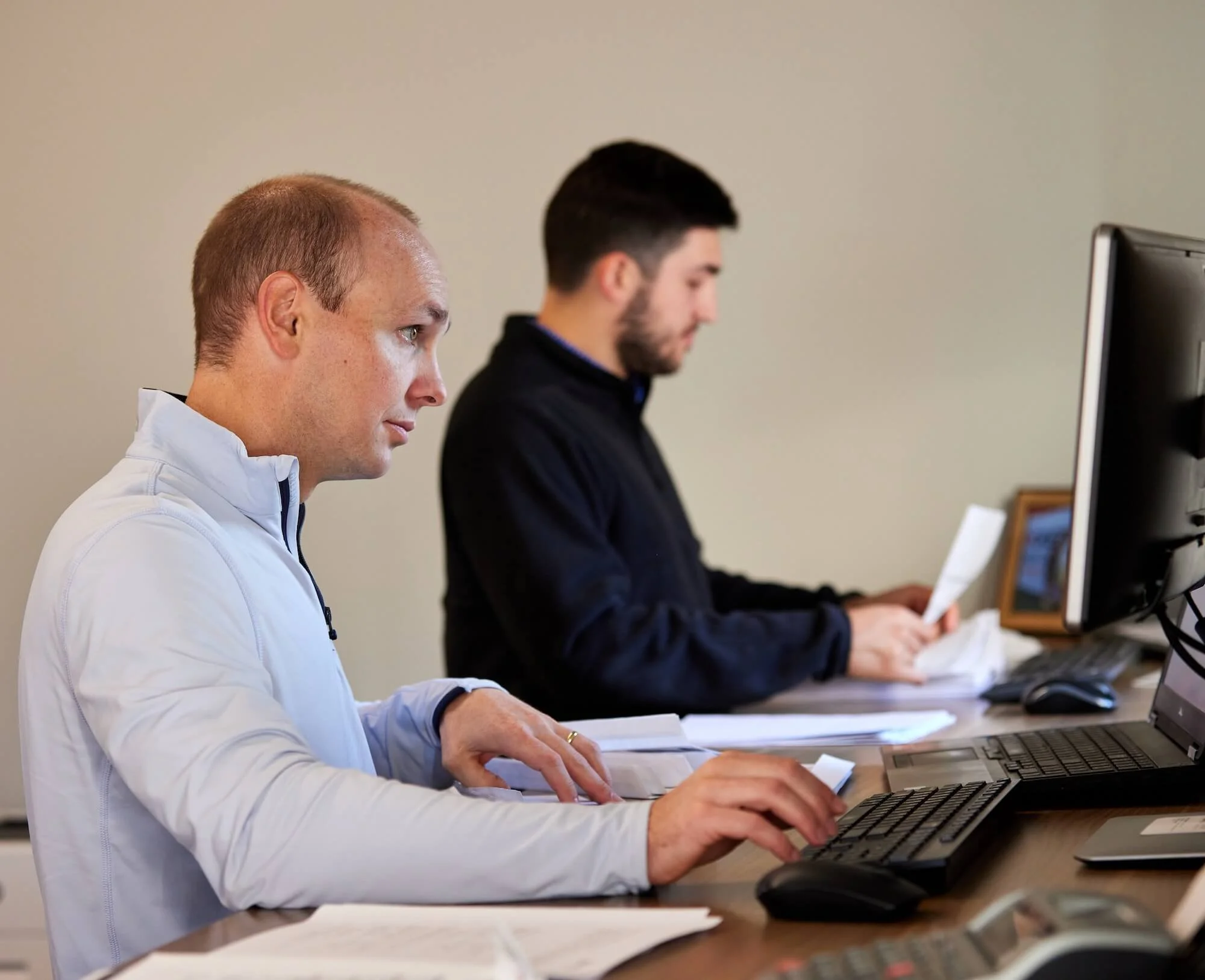 SecurAlarm team working together at computers.