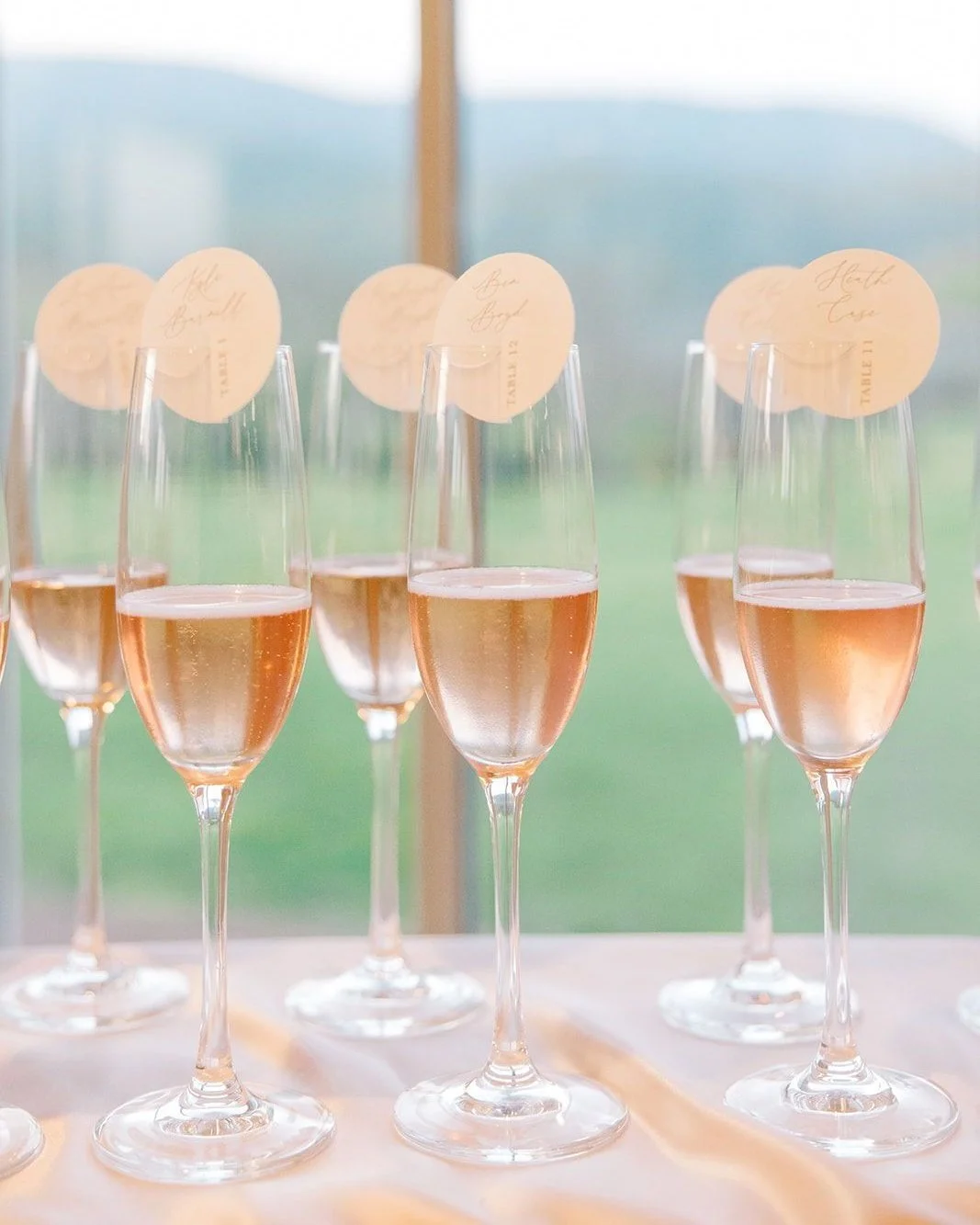A toast and a place card 🥂⁣
⁣
These custom escort cards were designed to be affixed to each glass of champagne&mdash;welcoming guests with a celebratory sip while guiding them to their seat. A small detail, but one that sets the tone immediately and