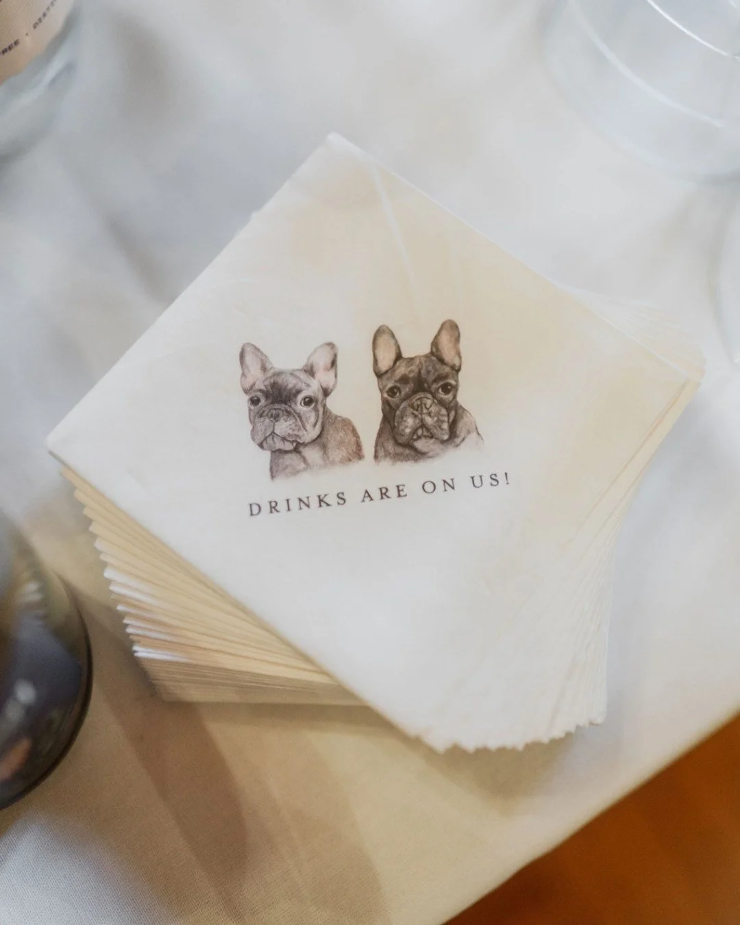 These custom cocktail napkins feature the true VIPs of the day&mdash;the bride and groom&rsquo;s French bulldogs&mdash;because no wedding celebration is complete without a nod to your four-legged family members.

Perfect for the bar, cocktail hour, o