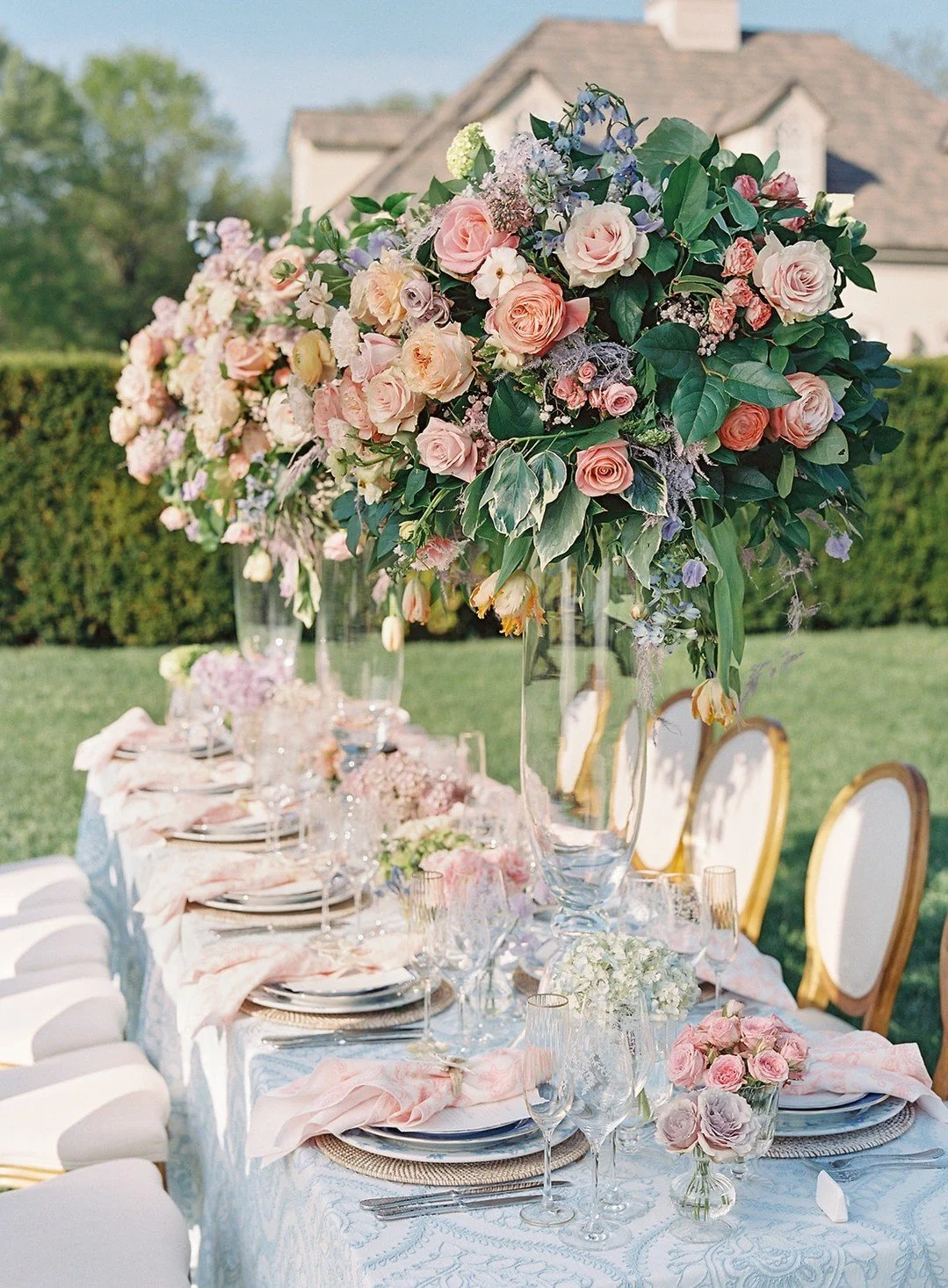 A tablescape fit for the ton. 💐

From afar, the table feels like a garden in full bloom&mdash;lush florals spilling from towering arrangements, soft pastels layered across the linens, and sunlight catching every glass and gold rim. But up close is w