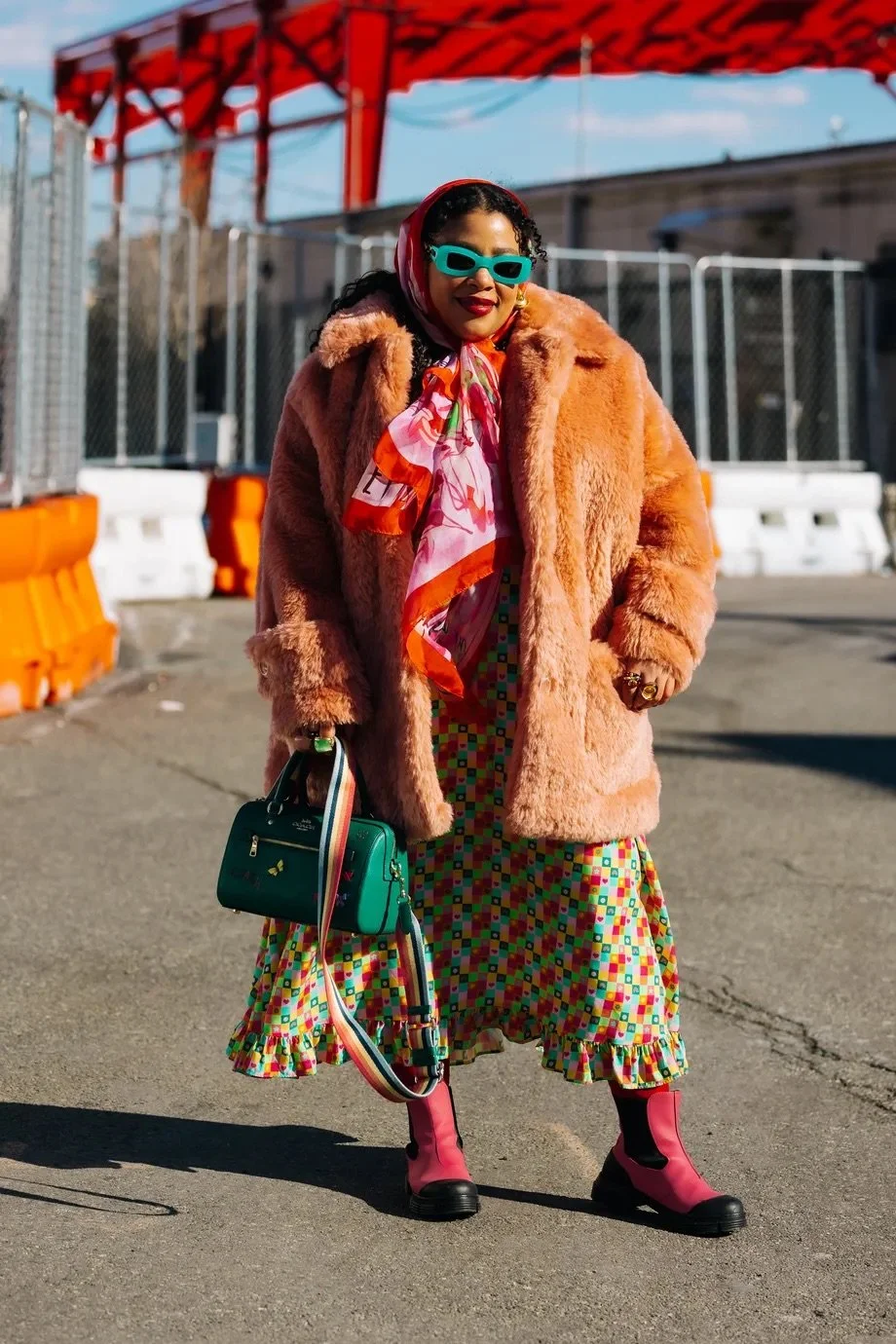 Greivy styled in a bold fur coat and vibrant accessories during New York Fashion Week Fall 2022 street style featured in The Cut.