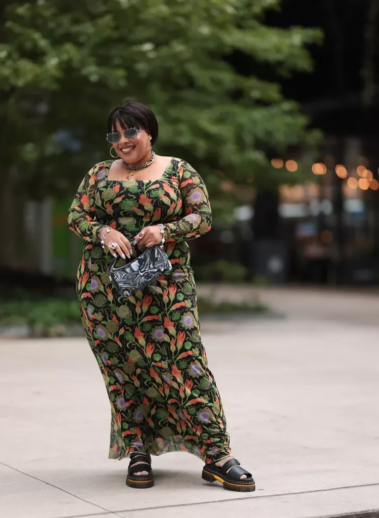 Greivy photographed in a casual floral dress and sandals for InStyle street style fashion feature.