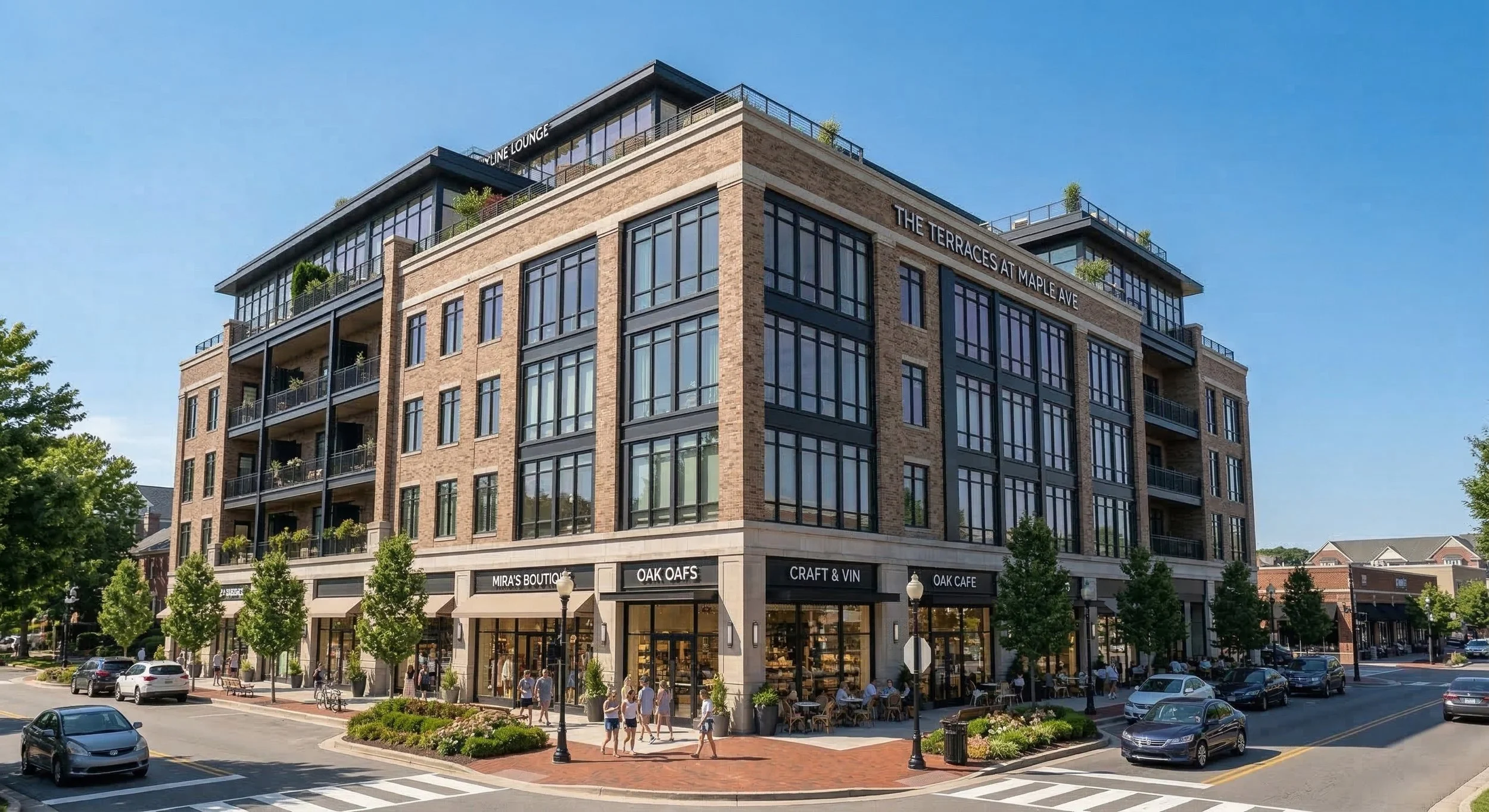 Street level view of a five story mixed use building on a street corner, featuring brick and cast stone architecture, multiple active retail storefronts with outdoor seating, street trees, and pedestrians on a sunny day.