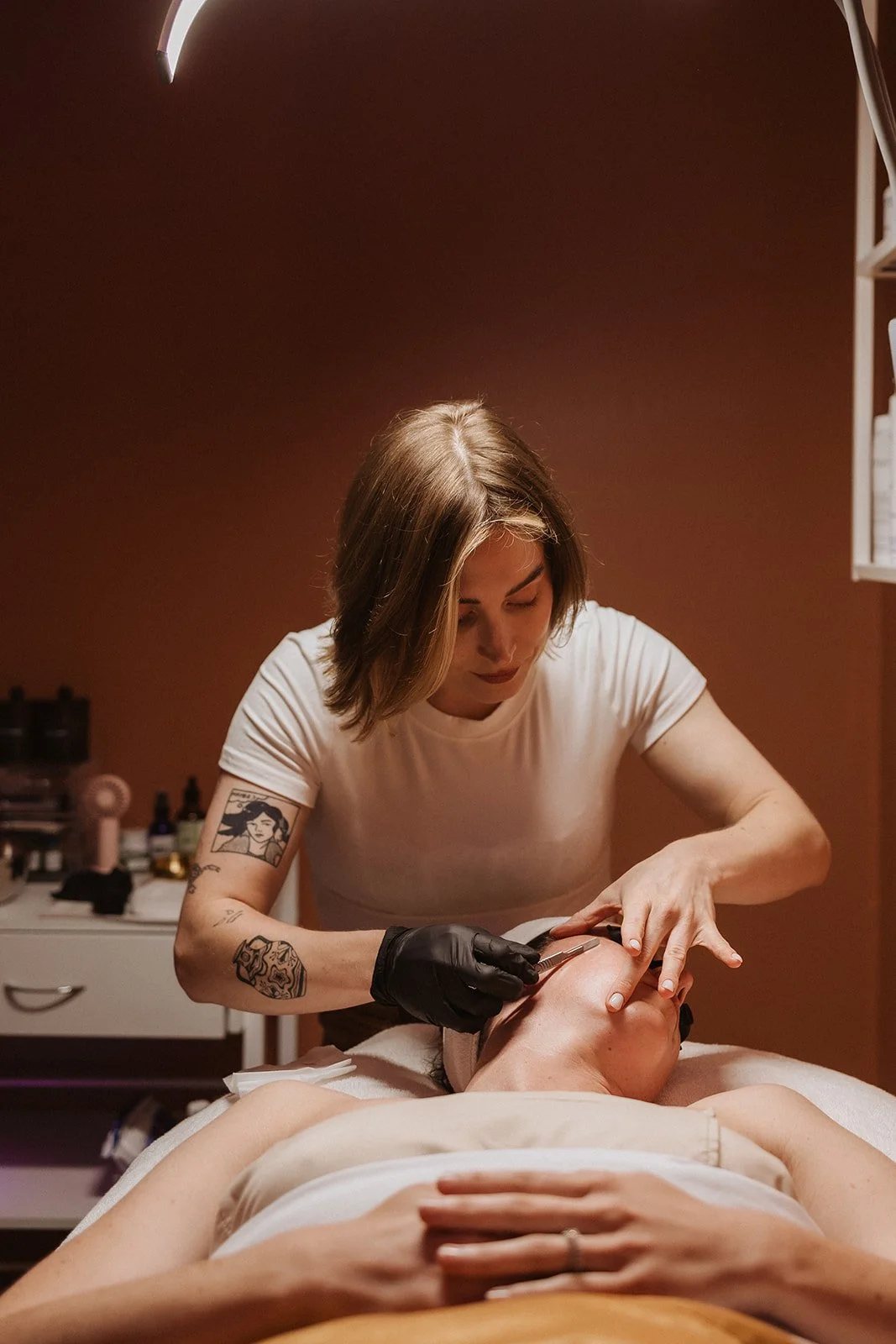 Woman performing a facial on a client