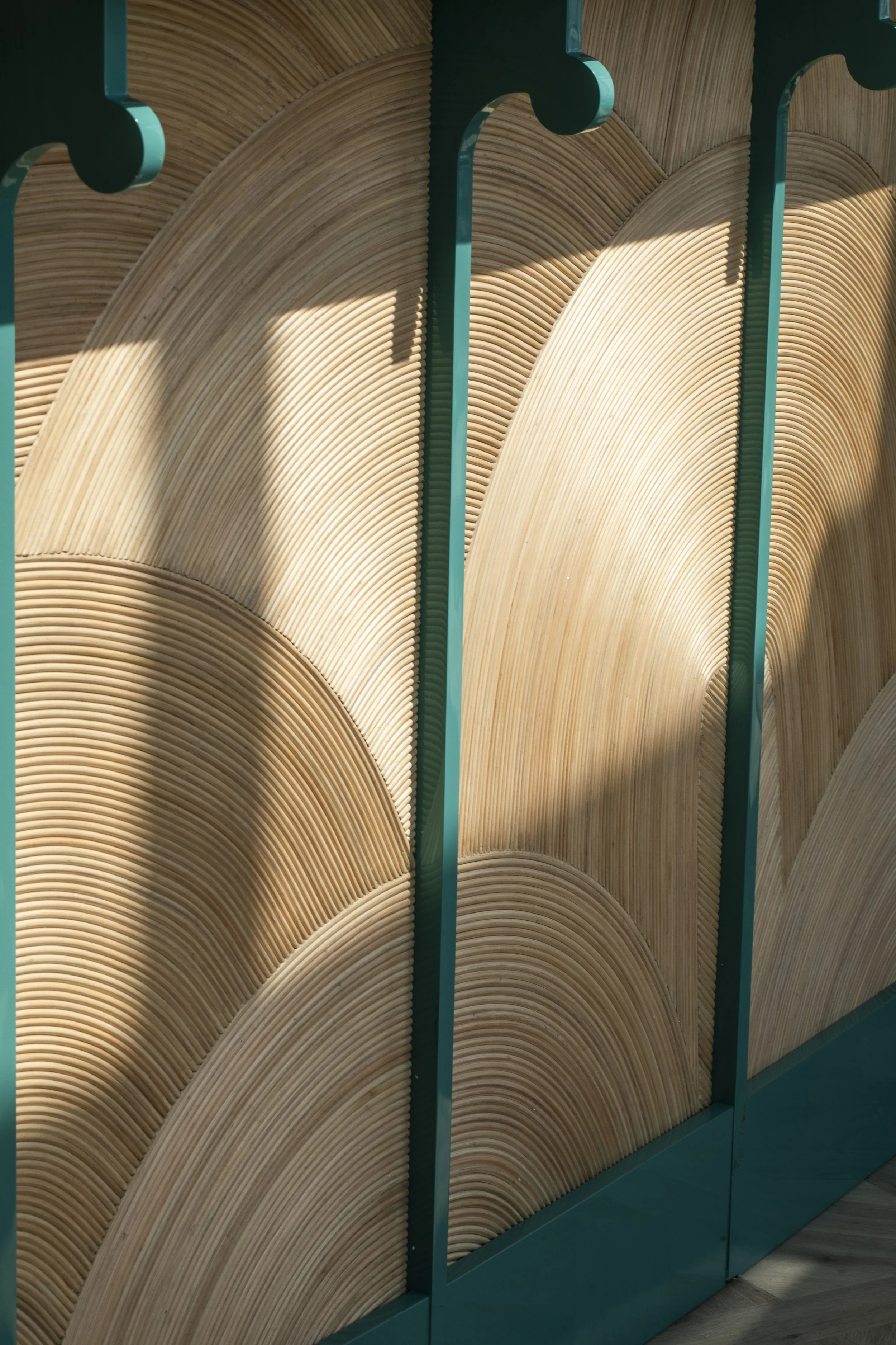 Rattan detail of the sushi bar. High gloss turquoise lacquer uprights with rounded details.