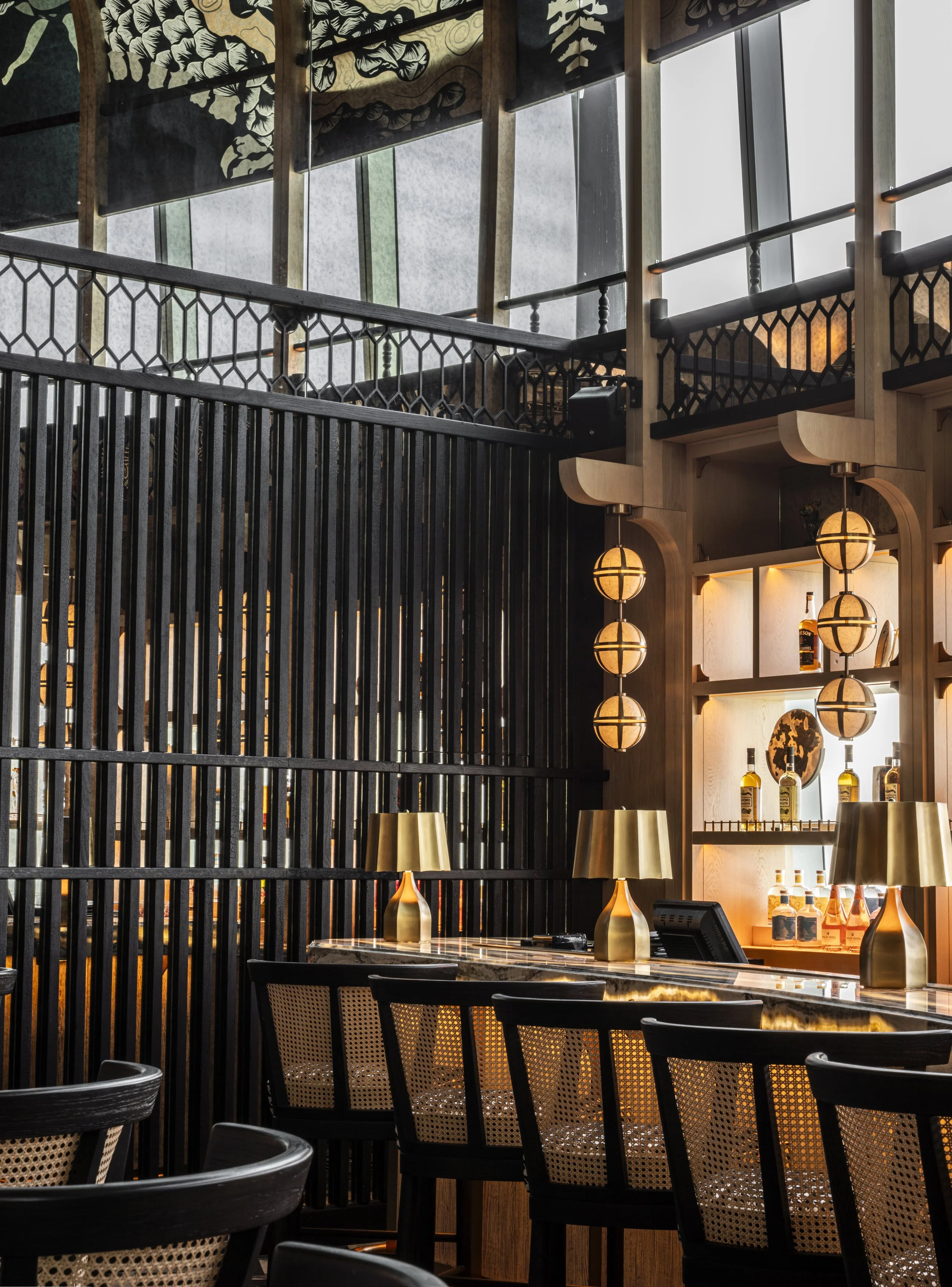 Close up of the White dragon bar with rattan backed bar stools and black charred timber slats.