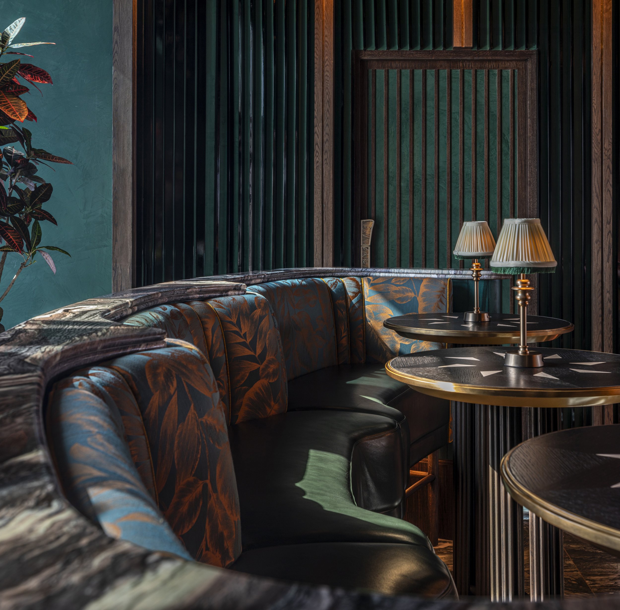 A close up of a high banquette with marble ledge behind.